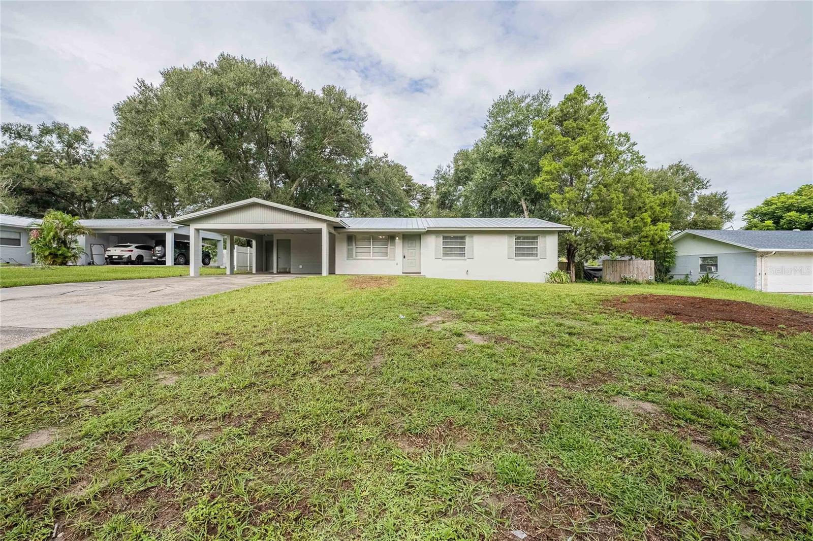 This beautifully updated 3 bedroom, 2 bath home in the 33809 area offers the perfect balance of convenience and comfort, just minutes from town amenities and with quick access to I-4 for commuters. Located in the desirable Wendell Watson Elementary and Lake Gibson Middle and High School district, the home sits in the quiet Cromwell neighborhood where the roads circle back to Walt Williams Road, keeping traffic low and the setting peaceful. Inside, you’ll find a large living room, den, and dining area along with inside laundry for added convenience. Recent renovations include a new metal roof, updated AC and heating, modern kitchen with new cabinets, countertops, and matching Whirlpool appliances, fully refreshed bathrooms with new tile, vanities, plumbing fixtures and lighting, as well as new flooring and fresh paint inside and out. Outside, you’ll enjoy relaxing on the screened back porch while your pets play in the fenced, shaded yard, and the oversized driveway with a double carport provides plenty of space for parking. With no HOA restrictions, you have the freedom to park your boat, RV, or other toys right at home. The market is heating up and rates are coming down — don’t wait! Schedule your showing today and make this move-in-ready home yours.