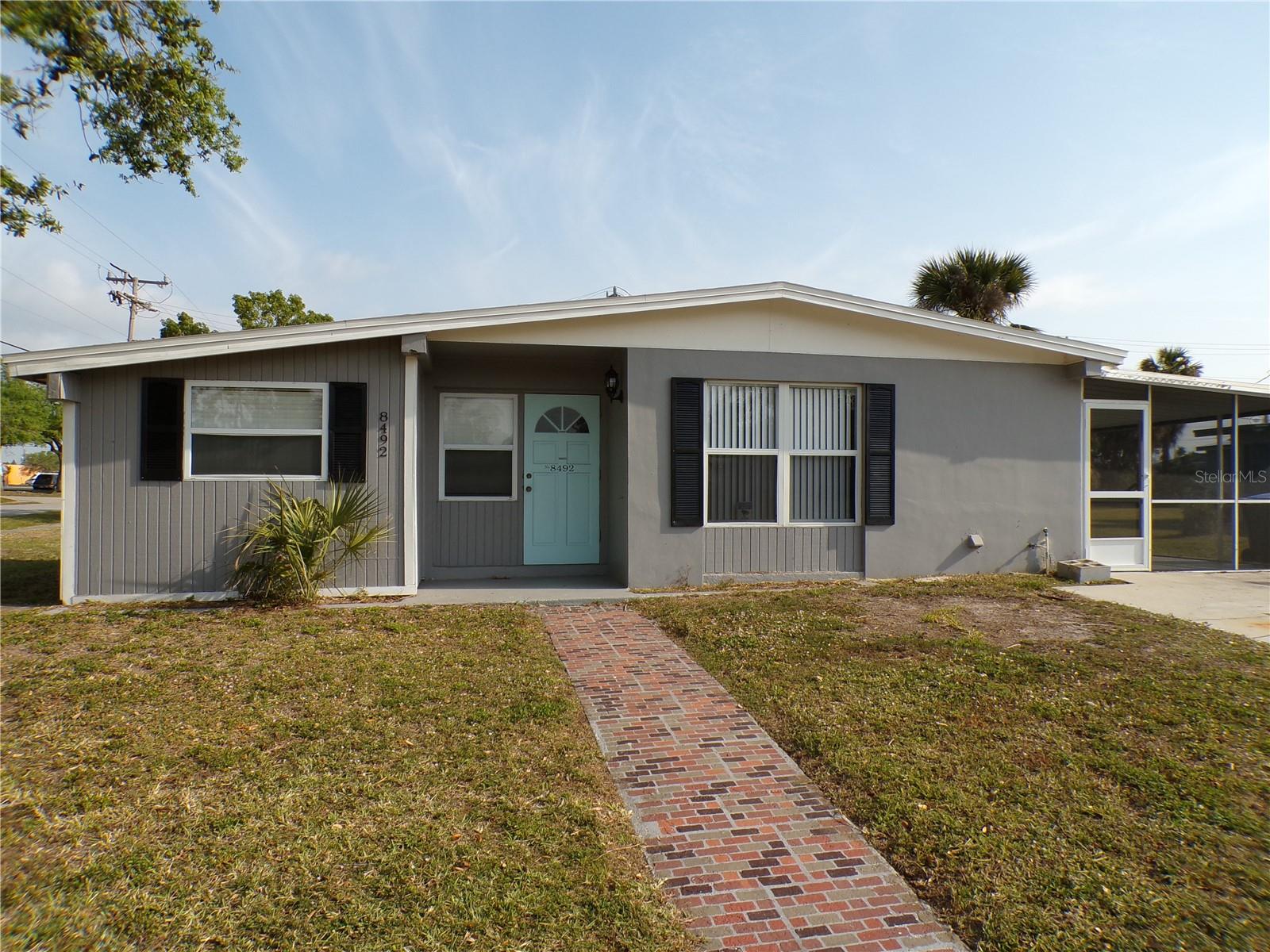 Check out this beautiful 3 bed 1 bath home with BONUS room now available for annual lease. Freshly painted with a complete bathroom remodel and all new flooring this beauty has granite and stainless in the kitchen and a huge screened lanai. Situated on a large corner lot with city water and sewer in a quiet neighborhood, this home is move in ready. Washer and dryer are provided and there is a large storage room off of the lanai. Your rent includes lawn maintenance so you can sit back and enjoy this Paradise location.