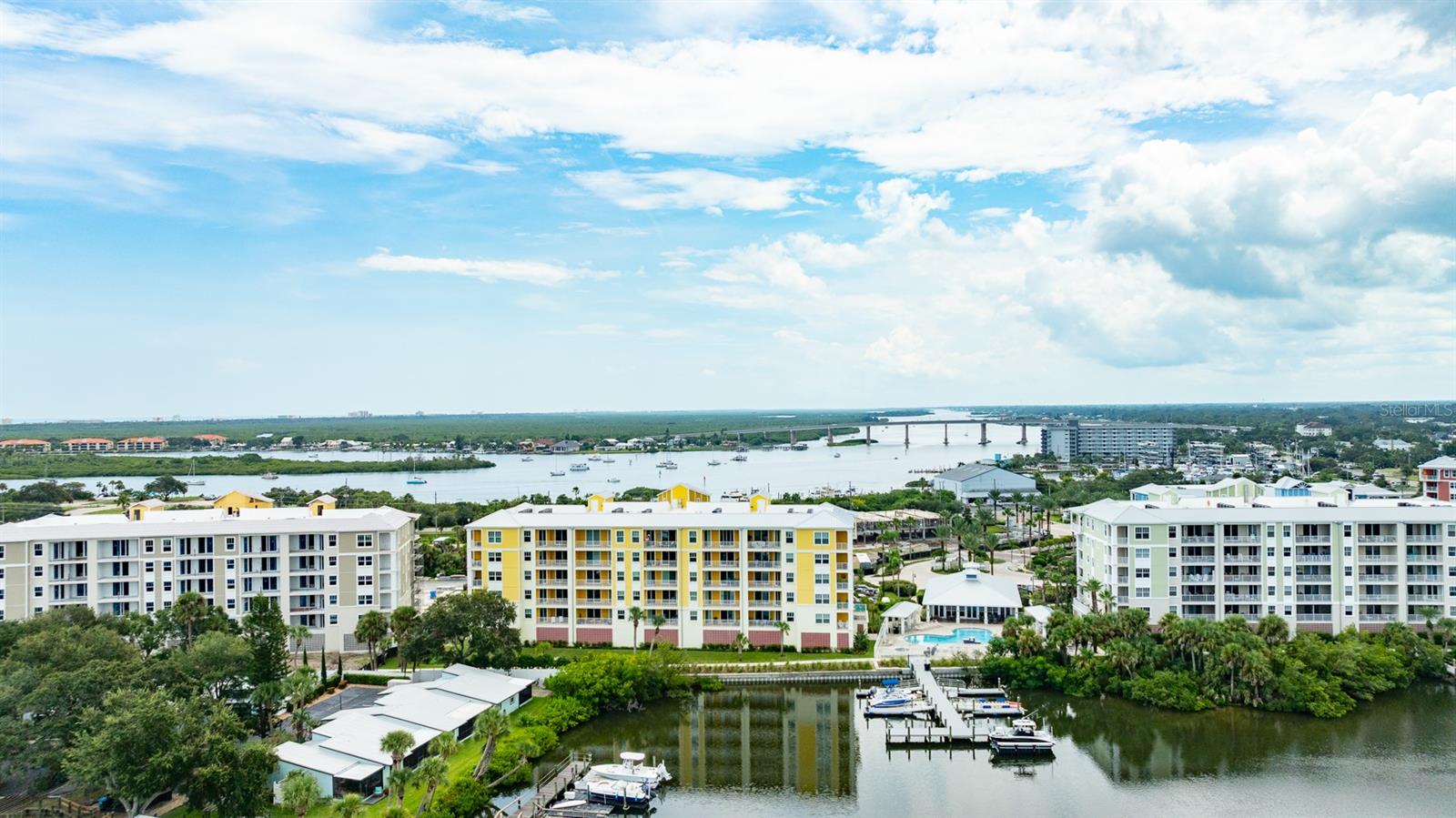 ''THE PERFECT BEACH CONDO'' can be yours, but don't wait too long. This elegant first-class Brand New 5th floor condo offers unparalleled views, design, craftmanship and exceptional amenities. Riverwalk, a gated community located on the North Causeway in NSB has a gorgeous Pool, Jacuzzi, Gym, Movie Theater, Club House and Modern Kitchen! Located on the Indian River in New Smyrna Beach with stunning 5th FLOOR VIEWS that greet your eyes with tranquility where you can see dolphins and Manatees off your private balcony as you overlook the marina, mangroves, river and Ponce Inlet Lighthouse. I call this ''The Perfect Beach Condo'' a 20 minutes walk or 3 minutes drive to the Flagler Avenue Beach with 3 specious bedrooms and 2 full bathrooms/showers plus a very large living area, high ceilings, a huge open floor plan and a tasteful blend of high end features complete this home masterpiece. This modern coastal inspired design is truly remarkable inside and out. Features include a DEEDED 25/ft. BOAT SLIP on Riverwalk Marina, upgraded cabinets, quartz countertops, tray ceilings, crown molding, tile floors throughout, gourmet kitchen, upgraded GE appliance, large pantry, lots of closets and storage space and under building parking. The upgraded building code provides high impact windows and plenty of natural lighting.
