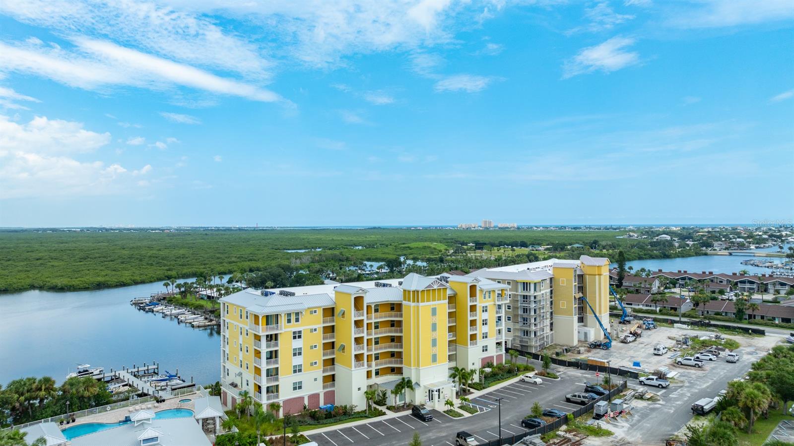 ''THE PERFECT BEACH CONDO'' can be yours, but don't wait too long. This elegant first-class Brand New 5th floor condo offers unparalleled views, design, craftmanship and exceptional amenities. Riverwalk, a gated community located on the North Causeway in NSB has a gorgeous Pool, Jacuzzi, Gym, Movie Theater, Club House and Modern Kitchen! Located on the Indian River in New Smyrna Beach with stunning 5th FLOOR VIEWS that greet your eyes with tranquility where you can see dolphins and Manatees off your private balcony as you overlook the marina, mangroves, river and Ponce Inlet Lighthouse. I call this ''The Perfect Beach Condo'' a 20 minutes walk or 3 minutes drive to the Flagler Avenue Beach with 3 specious bedrooms and 2 full bathrooms/showers plus a very large living area, high ceilings, a huge open floor plan and a tasteful blend of high end features complete this home masterpiece. This modern coastal inspired design is truly remarkable inside and out. Features include a DEEDED 25/ft. BOAT SLIP on Riverwalk Marina, upgraded cabinets, quartz countertops, tray ceilings, crown molding, tile floors throughout, gourmet kitchen, upgraded GE appliance, large pantry, lots of closets and storage space and under building parking. The upgraded building code provides high impact windows and plenty of natural lighting.