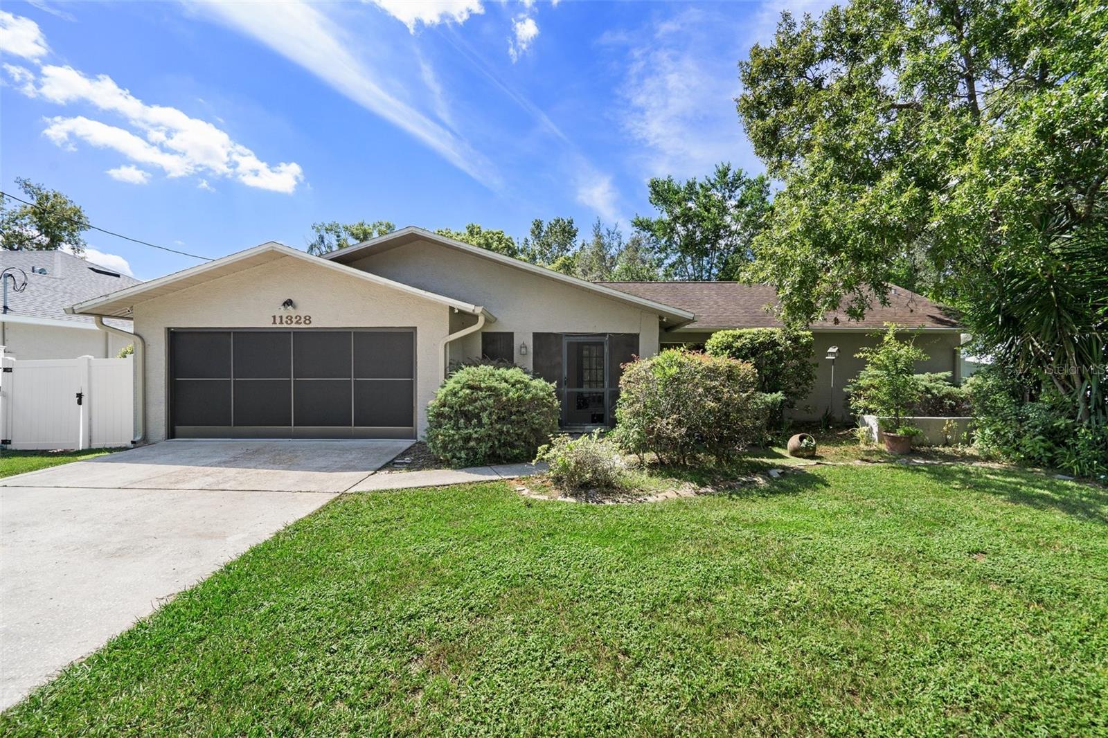 This delightful split-style home offers a perfect blend of comfort and privacy. Nestled in a tranquil neighborhood, it's the ideal place to call home. With a total of three bedrooms and two bathrooms, it's well-suited for families or individuals seeking a cozy and inviting living space. As you enter the home, you'll find the spacious living room. To the right, you'll discover the master bedroom and en-suite bathroom. This retreat-like master suite provides a sense of privacy and relaxation, making it the perfect place to unwind after a long day. On the left side of the living room, you'll find the other two bedrooms. These well-appointed rooms offer versatility and can be used as guest rooms, home offices, or even a playroom for the little ones. The cozy kitchen is designed for both convenience and functionality. It opens up to a charming dining area, creating a warm and inviting space for family meals and gatherings. Natural light streams in, enhancing the overall ambiance. One of the standout features of this home is the private backyard oasis. Enclosed with vinyl fencing, you'll enjoy a serene and secluded outdoor space. Imagine spending mornings on your porch, sipping coffee, and admiring the beautiful azaleas in full bloom. This backyard provides the perfect setting for outdoor activities, gardening, or simply unwinding in nature's embrace. The property is located in a quiet and friendly neighborhood, ensuring peace and tranquility. For those seeking privacy and a connection with nature, this home offers the best of both worlds. Contact us today to schedule a private viewing and see for yourself the charm and comfort this home has to offer. Don't miss out on the opportunity to make this beautiful property your own. Overall, this home is a wonderful combination of a well-designed layout, a beautiful backyard, and practical features like the modified garage workspace. It's an inviting space that holds the promise of a comfortable and enjoyable lifestyle in a quiet neighborhood. Don't hesitate to call today to arrange your private viewing and explore the potential of making this house your home.