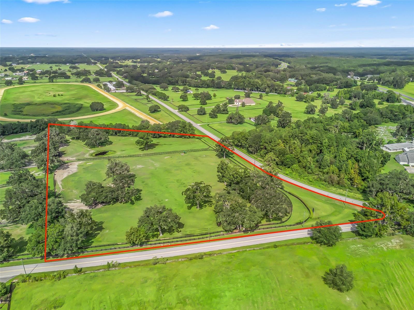 Beautiful 10 acre farm site in the heart of NW Ocala, conveniently located just 7 minutes to WEC and 8 minutes to HITS, nestled among some of the most beautiful farms in the area. The acreage has beautiful established pastures, and magnificent live oak trees making it the perfect location to build your dream farm.