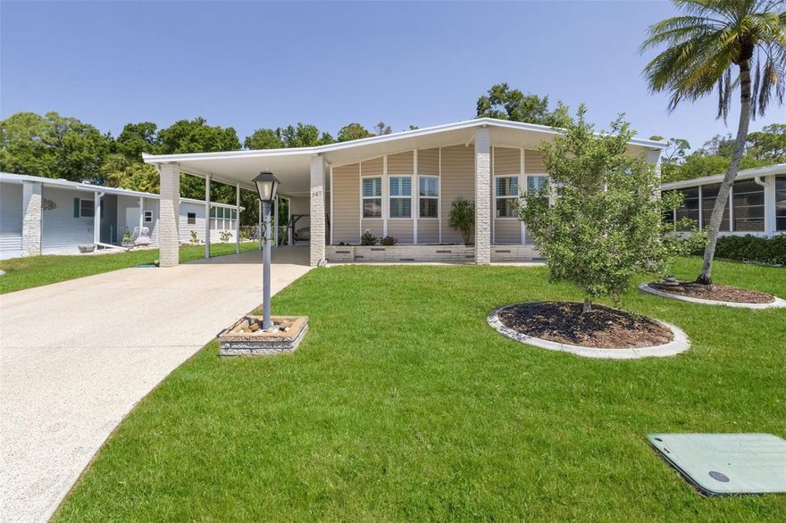 Brick pillars and custom landscape curbing greet you as you arrive at this inviting three-bedroom, two-bath retreat. The gleaming epoxy driveway leads to a spacious utility room with ample storage, a deep sink, and a water heater. Step inside to discover an airy, open-concept dining and living area that flows seamlessly into the kitchen. Here, you'll find a built-in convection oven and microwave, elegant maple cabinetry with two lazy-susan corners, sleek quartz countertops, a stylish tiled backsplash, stainless steel appliances, and a welcoming breakfast bar. Just off the kitchen, a generous wall pantry and a cozy morning room invite you to savor your coffee as sunlight streams in. The adjacent laundry area is equipped with a washer and dryer, as well as extra cabinets for convenience. The morning room opens into a carpeted Florida room, offering a large storage closet, direct access to the utility room, and a door leading to the carport. The primary bedroom, also carpeted, boasts a spacious walk-in closet and a luxurious ensuite bathroom with a double-sink vanity, a linen tower, an expansive walk-in shower, a skylight, and extra cabinetry. The split floor plan includes a versatile bedroom with laminate flooring, perfect for a home office, and a built-in double closet. The guest bedroom features plush carpeting and a double walk-in closet, while a handy linen closet sits between the bedrooms. The guest bathroom features a vanity, a tub and shower combination, and a skylight. The home features Plantation shutters, vaulted ceilings, and new low-e windows throughout. Among the added upgrades are an A/C unit with parts and labor warranty until 2030, an AMS membrane roof with a transferrable lifetime warranty, and new gutters and downspouts.  Welcome to La Casa, an enchanting community where 974 home sites are beautifully set among native trees, surrounded by spacious common areas and eight serene lakes. La Casa is perfectly located between Sarasota and Fort Myers. Enjoy easy access to shopping, sightseeing, golfing, and fishing, all while immersing yourself in the rich culture of Southwest Florida.  Experience the warmth of Southwest Florida’s winters in a relaxed environment, far from the east coast hustle. Our lush, mature landscaping reflects the dedicated care of residents and management.  Stay connected with our complimentary Wi-Fi at the Clubhouse, Activity Building, and Recreation Hall while you soak up the sun.  La Casa is a family-friendly haven where you can enjoy tranquility while remaining close to vibrant attractions. Come visit our charming oasis and discover why La Casa is the ultimate destination for snowbirds and year-round residents!