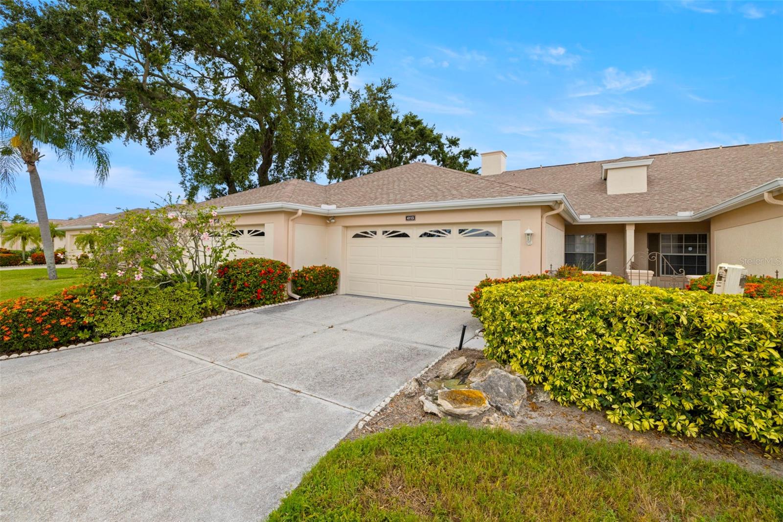 One or more photo(s) has been virtually staged. Come live the dream at Peridia Golf & Country Club in this low maintanence 2 bedroom, 2 bath, 2 car garage villa offering LAKE views. NO flood insurance required! Upon arrival to this meticulously maintained villa, you are greeted with a welcoming wrought iron gated courtyard and screened front porch entry. Inside you will find a bright and spacious open concept living area featuring plenty of natural light, high vaulted ceilings, fresh interior paint, and beautiful tile flooring for low maintenance. Ideal kitchen layout provides ample storage, inviting breakfast bar, Corian counter tops and closet pantry. Bonus breakfast nook to enjoy our morning coffee. Oversized dining and living space with extended enclosed Florida room that overlooks your tranquil water views providing use all year long. Spacious Primary Suite with his and her sizable walk-in closet. Ensuite boasts double sink vanity, shower stall, and linen storage. Split bedroom floor plan for privacy with guest bedroom located in a separate hallway. Guest bath has updated Granite vanity and shower/tub combo. Interior hall laundry closet for convenience. Center opening sliding doors to your Florida room lead to your outdoor patio for relaxing and enjoying beautiful Florida sunsets! Highly desirable two car garage for parking, golf cart space and storage. Peridia Golf and County Club is an amenity-rich community offering a full service Restaurant and Tiki Bar, community pool (one private pool for Fairway Trace residents), pickle ball and tennis courts, and clubhouse that hosts plenty of social activities! The 18 hole golf course was redesigned by Jed Azinger and Gordon Lewis with the ability to be challenged but also play in 3 hours. Just minutes to beautiful pristine Anna Maria Island beaches, Botanical Gardens, Downtown Bradenton Riverwalk, easy access to SR 70 and I-75 to UTC area shopping restaurants and more.