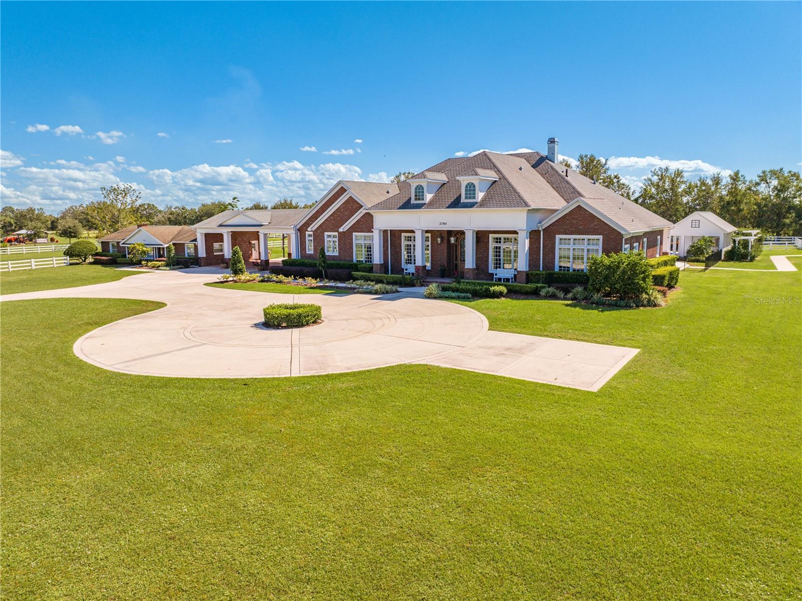 EXQUISITE EQUESTRIAN RETREAT SITUATED ON OVER 5 ACRES. WELCOME TO YOUR DREAM PROPERTY, AN EXTRAORDINARY ESTATE THAT OFFERS A LUXURIOUS LIFESTYLE COMBINED WITH UNPARALLED OUTDOOR LIVING AND EQUESTRIAN AMENITIES. NESTLED ON OVER 5 ACRES (5.84) OF BEAUTIFULLY LANDSCAPED PROPERTY, THIS REMARKABLE HOME BOASTS OVER 8000 (8261) SQUARE FEET OF LIVING SPACE DESIGNED FOR COMFORT, ENTERTAINMENT AND RELAXATION. THE MAIN RESIDENCE HAS 7 SPACIOUS BEDROOMS PERFECTLY DESIGNED FOR FAMILY AND GUESTS, 5 MODERN BATHROOMS AND EXPANSIVE OPEN CONCEPT LAYOUT WITH AN ABUNDANT NATURAL LIGHT, IDEAL FOR ENTERTIANING. THE STUNNING CHEFS KITCHEN IS THE CENTER HUB OF THE HOME. THE HOME FEATURES A HOME OFFICE/GOLF SIMULATOR FOR ALL OF THE GOLF ENTHUSIAST. THE OUTDOORS IS A TRUE OASIS. YOU WILL BE ABLE TO ENJOY YOUR VERY OWN LAZY RIVER/POOL/SPA ALL YEAR LONG. THE FIRE PIT IS PERFECT FOR THOSE COZY EVENINGS UNDER THE STARS. THE FULLY EQUIPPED OUTDOOR KITCHEN AND LIVING AREA IS PERFECT FOR DINING AND ENTERTAINING FRIENDS AND FAMILY. THE EQUESTRIAN AMENITIES ARE DESIGNED FOR HORSE LOVERS TO INCLUDE A BATHROOM, TACK ROOM AND SLIDING DOORS ON 3 SIDES. THE MASSIVE GARAGE IS 1800 SQUARE FEET WITH 4 ROLL UP DOORS FOR ALL OF YOUR VEHICLES AND TOYS, IDEAL FOR ENTHUSIASTS AND HOBBYISTS PLUS A 1324 SQUARE FEET PORTICO SEPARATING THE MAIN HOUSE AND THE GUEST HOUSE. IF YOU THINK THAT IS ALL, THINK AGAIN!! THIS PROPERTY COMES WITH A 3 BEDROOM AND 2 BATHROOM ,1620 SQ FT. GUEST HOUSE, PERFECT PRIVATE RETREAT FOR GUESTS OR EXTENDED FAMILY, ENSURING EVERYONE HAS PLENTY OF SPACE. THIS ESTATE IS TRULY ONE OF A KIND. PLEASE TAKE A LOOK AT THE WALK THROUGH VIDEO.