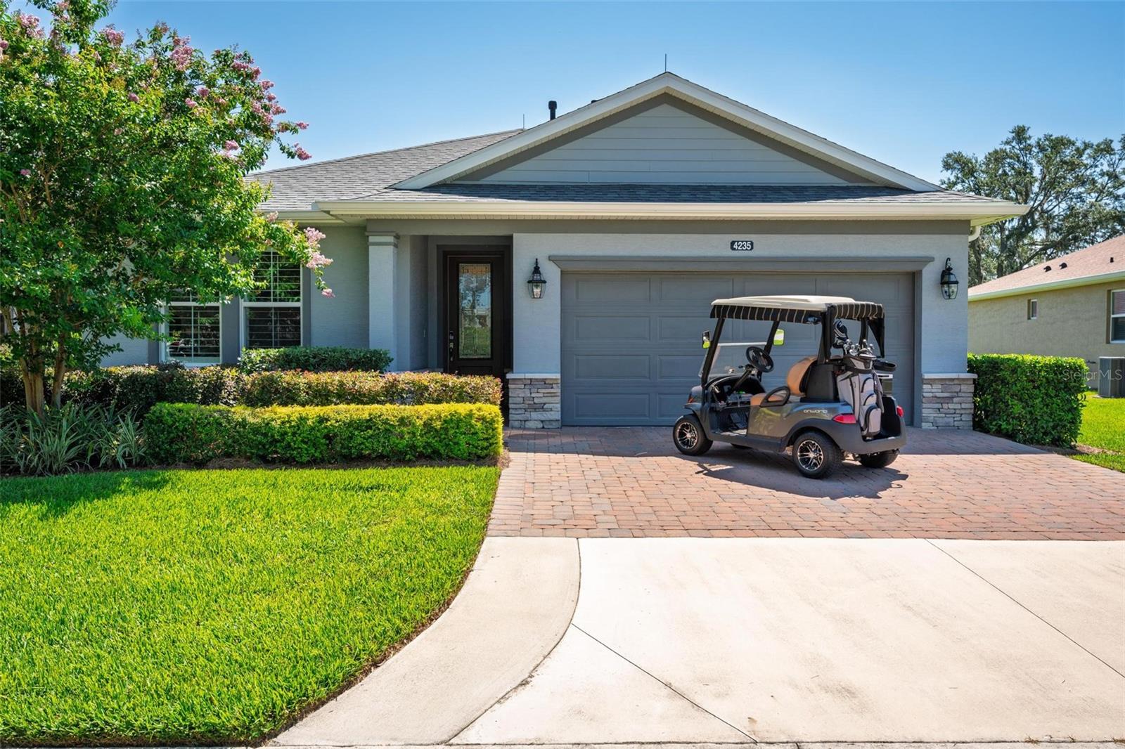 Ready to Move-In! Award Winning Home, built in 2020 by SHEA Homes builder, known for his high quality homes. This pristine 3 Bedrooms, 2 bathrooms and extra 1 Half Bathroom, tiled throughout, located on a bigger lot with open view on the grassy retention area and the 18-hole executive golf course, has multiple upgrades: Kholer Generator 26K, lightening rods, extra landscaping, extended driveway, water softener, Epoxy floor in the 2 car garage, window treatments, shutters, all closets done and more. Covered Patio facing Sunrise, nice outdoor paved area with a custom made outdoor BBQ. Privacy and space. Furniture and Golf cart are for sale extra. Come and enjoy this very well located gated community, only 5 min from the renowned World Equestrian Center, Publix supermarket and nice restaurants. Relax by the community pool, take advantage of the multiple activities offered to its residents, gym classes, spa, beauty salon, kayak, fishing, tennis, pickleballs, miles of trails for your morning walk and bike rides. Pet Friendly with it dog parks. Low maintenance that includes your landscaping and No CDD for this home. It is a 55+ street in this multi generational friendly community.