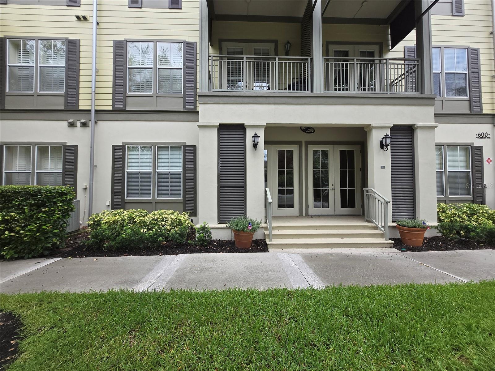 Sought after Carlyle Residence ANDOVER model in Celebration. This luxury 1st floor condo built in 2007 is located on a quiet street in the downtown area. Only 2 blocks from specialty shops, restaurants, cafes and activities - Christmas, 4th of July etc. - everything Celebration is known for. Spacious true 2 bedroom/2bathroom split floor plan with 1196 sq ft has been well maintained. Enter through front door on side of unit and2nd bedroom will be to left and 2nd bathroom to right. Follow hallway ahead to large open living room. To the left will be French doors opening to covered patio. To the right of living will be dining room and kitchen. In kitchen/dining room area is laundry closet with full sized premium washer ang dryer. Next to kitchen is door to private 1 car attached garage. This upscale condo features 10' ceilings. granite countertops, stainless steel kitchen appliances, hardwood and tile flooring and crown molding. Within the Carlyle complex are additional parking spaces for residents only. Well run HOA includes use of Celebrations private numerous swimming pools, hot tubs, tennis and basketball courts, parks and playgrounds for your enjoyment. Celebration Park, located in downtown Celebration is a short walk from the unit.Celebration also boasts of a public golf course with clubhouse, numerous walking and biking trails throughout. Great location being close to major roads and Disney.