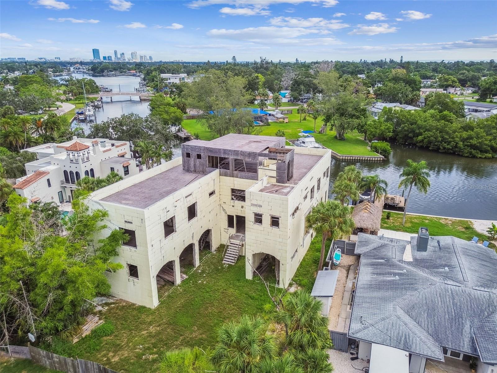 Short Sale. Short Sale. A rare chance to own and complete a one-of-a-kind waterfront estate—this striking new construction home stands as the tallest single-family residential structure in St. Petersburg, offering unobstructed 360-degree views of the bay, city skyline, and beyond. Please note: the home is currently a shell and not yet finished. Interior build-out is required, offering a blank canvas to bring your vision to life. Appraised As-Is at $3.8M (appraisal in hand), with a completed value exceeding $7M, this property presents tremendous upside for builders, investors, or end-users seeking to customize a luxury waterfront masterpiece. Constructed with ICF (Insulated Concrete Form) for superior strength and energy efficiency, the structure withstood two recent hurricanes without any water intrusion. Located on a deep canal with immediate open water access, the property features a concrete seawall and dock that can accommodate up to an 80-foot yacht. Just 10 minutes from Downtown St. Pete and minutes from Gulf beaches, this property offers elite boating access, breathtaking views, and the chance to create something truly iconic. Short sale—subject to bank approval.