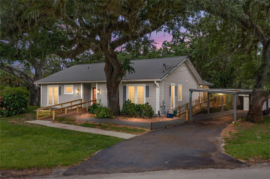 Tucked away on a peaceful corner lot of over an acre in LaBelle, this inviting three-bedroom, two-bathroom home offers a rare blend of space, privacy, and natural beauty. Set along a serene creek that leads out to the Caloosahatchee River, the property provides a tranquil backdrop where you can enjoy the sights and sounds of nature right from your own backyard.  From the moment you arrive, the expansive lot and thoughtful features set this home apart. A handicap-accessible ramp ensures ease of entry, while the two-car carport offers convenient covered parking. For those who enjoy hobbies or need additional storage, the on-site shed and workshop provide plenty of flexibility for tools, equipment, or creative projects.  Inside, the home welcomes you with an open-concept layout designed for comfortable living and effortless flow. The main living areas feel bright and connected, making it easy to entertain or simply enjoy everyday life. The kitchen has a large island, lots of storage space, and windows for natural light.  The primary suite serves as a private retreat, complete with its own en suite bathroom and a spacious walk-in closet. Two additional bedrooms and a second full bathroom offer versatility for guests, family, or a home office.  One of the true highlights of this property is the expansive screened-in patio, where you can unwind while overlooking the creek and the surrounding wooded landscape. Whether you’re sipping your morning coffee, hosting weekend gatherings, or enjoying quiet evenings as the sun sets, this outdoor space captures the essence of relaxed Florida living.  With its generous acreage, waterfront access, and peaceful setting, this property offers a unique opportunity to enjoy both comfort and connection to nature—all while still being close to I-75.