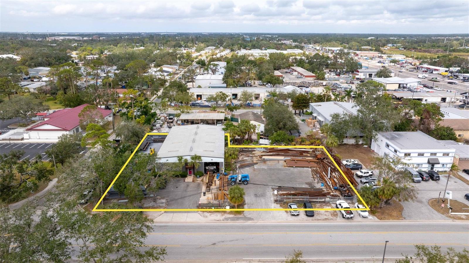 6000+ SF Industrial (IGD) building. Corner lot being sold with adjacent lot providing ample room for storage and parking on .754 ACs. Eaves Height is 16' to ~18.5' peak height. Warehouse is clear span. There are two overhead doors (12x12 and 12x14). Property has 3phase electric. There is a stairway to storage area above offices. Property is located minutes to downtown Sarasota and within an Opportunity Zone.