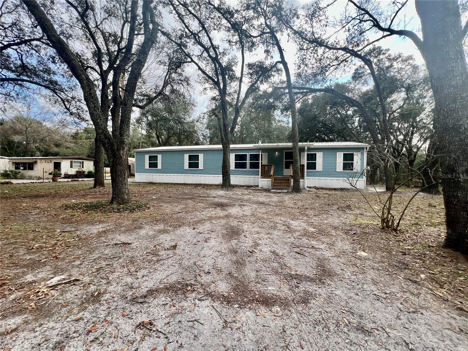 Seller is offering $5,000 towards buyers closing costs or prepaids with a full price offer. Immerse yourself in the tranquility of this meticulously updated 4 bedroom 2 bathroom manufactured home, perfectly situated on a generous 0.70-acre lot. Boasting modern amenities and thoughtful renovations throughout, this property offers the ideal blend of comfort and convenience. This home has undergone extensive updates, ensuring a contemporary living experience. The Chef-inspired kitchen features granite countertops, stainless steel appliances, and ample cabinet space. Enjoy ample space for relaxation and entertainment in the generously sized living area with a wood burning fireplace. Retreat to the Primary Suite, complete with spa-like ensuite bathroom, large Tub , walk in closet, large shower, two separate vanities and a beautiful Chandelier. Forth bedroom could be made into a study/office, playroom or more. With 0.70 acres of land, there is plenty of room for outdoor activities, gardening, or even potential expansion. Situated in a desirable area, this property offers easy access to amenities, schools and major thoroughfares. Fiber Optics is available. This property is close to the world famous Suwannee River and Manatee Springs State Park for all your recreational fun including boating, fishing, swimming, snorkeling,walking trails, and Clay Landing boat ramps. Don't miss out on this incredible opportunity to own a beautifully updated manufactured home on a sizable lot. Schedule your showing today and experience the epitome of modern country living!