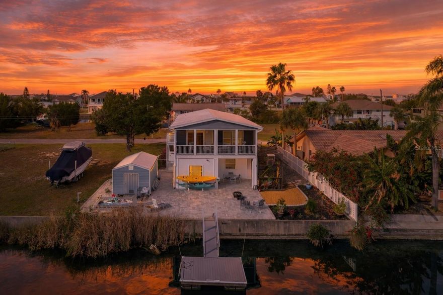 One or more photo(s) has been virtually staged. COASTAL NEWER WATERFRONT HOME in Hernando Beach—just reduced $10,000! Built in 2022 by TownHomes, LLC, a Florida-based builder known since 2005 for heavy-duty modular construction designed for strength and durability in hurricane-prone areas, this move-in-ready 3-bedroom, 2-bath home delivers the Florida lifestyle buyers dream of—73 FT of WATER FRONTAGE, seawall, and a floating dock, plus spectacular sunrise views to start every day right. Enjoy breezy outdoor living from the 27 FT long upper screened porch, and downstairs you’ll love the covered 14x11 porch and pavered patio—perfect for grilling, relaxing, or entertaining after a day on the water. Inside, the home shines with easy-care vinyl flooring, crown molding, and charming wood cornices accenting the living room sliders and windows. The bright kitchen features white cabinetry, a built-in pantry, and a breakfast bar for casual meals and conversation. The primary suite is a true retreat with a walk-in closet and an ensuite bath offering dual sinks, a built-in linen closet, and a walk-in shower with seat. Downstairs is where the fun really begins—bring your hobbies, toys, and projects! You’ll have a 2-car carport, RV parking, a 1,000 lb outdoor lift, and an impressive 737 SF workshop, plus a large shed with a matching metal roof. And for animal lovers, the catio is a standout—ideal for cats or even tropical birds (parakeets too)! Located in charming Hernando Beach, you’ll enjoy **Gulf access via the nearby community boat lift—just minutes away—**making it easy to get on the water for fishing, cruising, and sunset runs. If you’ve been searching for an affordable waterfront home that’s truly move-in ready, with a metal roof, newer build, and extras you rarely find—this one checks all the boxes. Live the coastal lifestyle you’ve been waiting for!