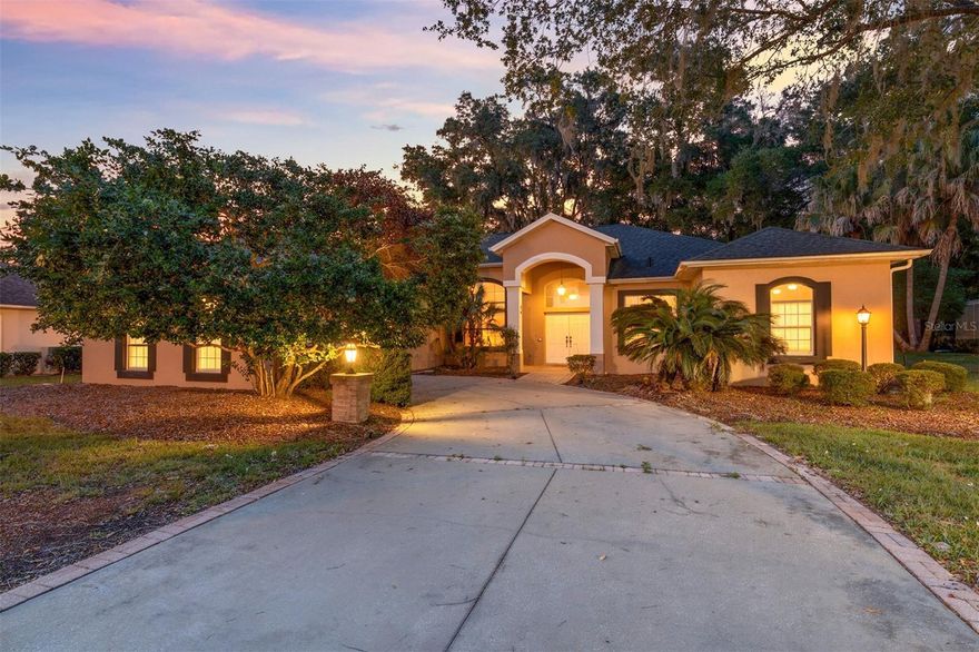 On a tree-lined street among beautifully maintained homes, this custom-designed, oversized two-bedroom, two-bath residence in Fairway Estates offers a peaceful retreat within Rainbow Springs Country Club. The backyard overlooks what was once the fairway, now a private greenspace that provides a tranquil, natural backdrop to enjoy for years to come. A double-door entry opens into a flexible family and dining area, where triple sliding doors lead to an expansive outdoor living space. The backyard is a highlight, featuring a covered patio and an integrated pergola with built-in bench seating, ideal for quiet mornings, evening gathering or effortless entertaining. The home’s central living room maintains a seamless indoor-outdoor connection with direct access to the patio. The well-planned kitchen serves as heart of the home, offering a center island with bar seating, a breakfast nook with custom corner built-ins, and generous cabinetry, with a spacious family room with amazing views of the outside green space. The primary suite is a spacious sanctuary, easily accommodating a king-sized bed with room for a sitting area. Its en-suite bath includes dual sinks, vanity seating, a separate water closet, and a large walk-in shower accented with glass block and tile. The split-bedroom layout ensures privacy, with guest accommodations positioned on opposite side of the home. A practical laundry room with a utility sink and additional storage completes the thoughtful floor plan. Living in Rainbow Springs Country Club enhances the experience with access to the private residents’ park on the Rainbow River, along with a clubhouse, pool and tennis courts. With its prime location, functional layout and exceptional outdoor living, this Fairway Estates home offers a rare blend of tranquility and active Florida lifestyle. Schedule your private tour today to experience the peace and privacy this property provides.