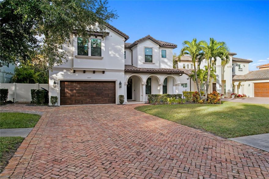 Under contract-accepting backup offers. Welcome to this truly one-of-a-kind oasis in the heart of sought-after South Tampa. Thoughtfully reimagined with top-of-the-line finishes and intentional design, this exceptional residence represents the pinnacle of luxury living. Upon arrival, a pavered motor court provides ample parking and an immediate sense of arrival. Just off the garage, a highly functional mudroom features a custom built-in cubby system for everyday convenience. Entering the home, you are instantly embraced by a warm, inviting atmosphere that carries throughout. A private office just off the entry offers excellent natural light, built-in shelving, and the privacy ideal for working from home. Across the hall, a striking, restaurant-quality wine refrigerator and display wall create a dramatic focal point, perfectly positioned adjacent to the parlor—an ideal space for entertaining or easily reimagined as a formal dining room. The heart of the home unfolds into a spacious family room that opens seamlessly to the stunning kitchen and dining area. Quartz countertops shimmer under abundant light, while beautifully crafted cabinetry enhances the airy, refined feel. Ample storage abounds, including generous island cabinetry and an oversized walk-in pantry. Tucked privately off the family room is a well-appointed guest bedroom and pool bath, offering comfort and seclusion for visitors. Ascending the staircase, custom millwork highlights the home’s thoughtful design and elevated craftsmanship. At the top of the stairs, the first guest bedroom features ample closet space and an en-suite bath and could easily serve as a secondary entertainment or bonus room. Down the hall are two additional guest bedrooms and a spacious shared bath with double sinks and a tub/shower combination. A large laundry room is conveniently located between the guest quarters and the primary suite. The primary suite is a true retreat, offering dual walk-in closets, space for seating, custom motorized shades, and a luxurious spa-like bath that leaves nothing to be desired. The backyard is the ultimate setting for relaxation and entertaining, anchored by a stunning fireplace and accented with elegant chandeliers. An oversized outdoor kitchen counter, built-in beer taps, and grill make gatherings both large and intimate feel effortless. The exceptional pool and spa by Hive Outdoors strike the perfect balance between sophistication and fun. Turfed side yards ensure easy maintenance, while a tucked-away putting green offers the perfect place to unwind and enjoy the Florida lifestyle.