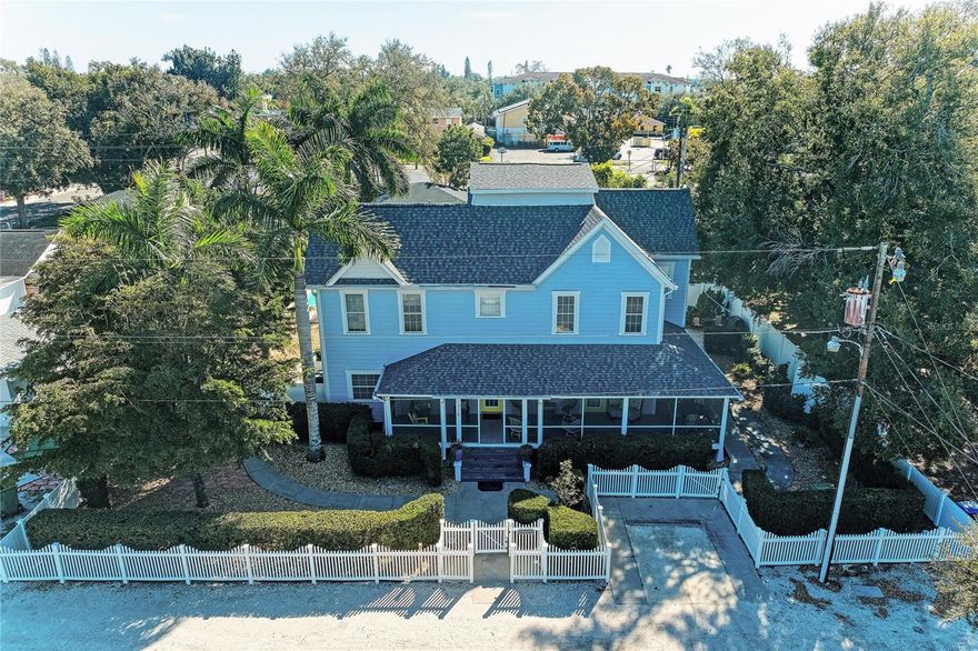 Located in the heart of Bradenton’s vibrant Village of the Arts, this expansive pool home offers a rare combination of character, space, and flexible zoning just minutes from downtown. Set on an oversized lot of more than a quarter acre, the property provides generous indoor and outdoor living with endless possibilities for both residential and mixed-use buyers.

A charming, screened wrap-around porch welcomes you inside, setting the tone for a home filled with classic architectural details, wide open living areas, and a dramatic central staircase. With 4 bedrooms and 3.5 bathrooms, the layout includes a spacious first-floor suite ideal for an owner’s retreat, guest accommodations, or multi-generational living. Multiple living spaces, three gas fireplaces, and abundant natural light create a warm and inviting atmosphere throughout.

The kitchen is designed for functionality and entertaining, offering ample workspace, an island, and an eat-in area that connects seamlessly to the rest of the home. Upstairs, additional bedrooms and living areas open to a second-floor deck, complete with a spiral staircase leading down to a private backyard retreat.

Outdoors, enjoy a true Florida oasis surrounded by mature palms and tropical landscaping. The large in-ground pool features an impressive lap lane, making it ideal for both relaxation and exercise. A screened rear porch and multiple outdoor seating areas provide the perfect setting for gatherings or quiet evenings at home.

Zoned T4-R Live/Work, this property offers exceptional versatility, allowing for a variety of potential uses including residential living, short-term rental (subject to local regulations), professional office, studio, or other creative opportunities within the district.

Recent improvements include new AC systems (2022–2023), a tankless water heater (2023), and a pool pump replaced in 2025, offering peace of mind for future owners. All appliances are included in the sale; furniture is optional and available under a separate bill of sale.

Conveniently located near downtown Bradenton, the Riverwalk, local dining, arts venues, LECOM Park, and cultural attractions, with easy access to Gulf beaches, SRQ Airport, UTC Mall, and more. This is a unique opportunity to own a distinctive property in one of Bradenton’s most sought-after and creative neighborhoods.