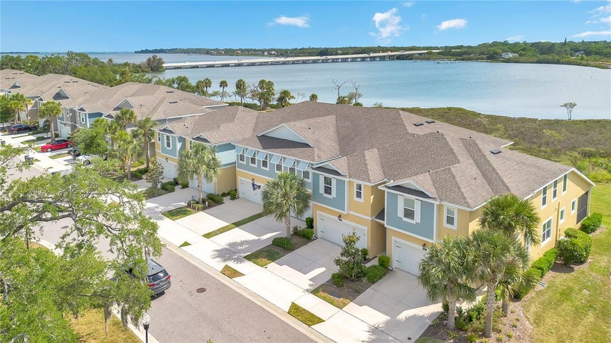 Experience elevated WATERFRONT LIVING in this beautifully upgraded townhome located within the gated community of Bayside Terrace on Old Tampa Bay. Whether you’re looking for a full-time residence, seasonal escape, or the perfect “Lock Up & Go” second home, this property offers the ideal blend of low-maintenance living and resort-style amenities. An added bonus — the flood insurance is ASSUMABLE to new buyers at currently only $1,101 annually. The HOA includes cable, internet, water, trash, roof and grounds maintenance, and gated access, leaving electricity as the only additional utility needed. This rare oversized waterfront unit stands out as one of the few in the community with expanded water views from the main living areas, creating a brighter, more open feel throughout the home. Enjoy stunning bay and conservation views from the kitchen, dining, living room, and even the primary suite upstairs. High ceilings and an open-concept layout make the home feel spacious and inviting, while the upgraded kitchen was designed with entertaining in mind. Features include an extended island, side coffee/bar station with glass-front cabinetry, spacious walk-in pantry, and over $57,000 in builder upgrades throughout the home. Upstairs, the waterfront owner’s suite feels like a private retreat with beautiful water views, dual vanities, soaking tub, separate shower, and an oversized walk-in closet. Two additional bedrooms plus a generous bonus room provide flexible space for a media room, game room, second living area, or hosting guests. The oversized upstairs laundry room located just off the primary suite adds everyday convenience. Downstairs, the current office can easily be converted back into a fourth bedroom if desired. Step outside to your screened lanai and enjoy peaceful mornings or sunset evenings overlooking the water. Bayside Terrace offers RESORT-STYLE amenities including an infinity pool overlooking Old Tampa Bay, waterfront fire pit, fitness center, outdoor grills, kayak launch and storage, and a waterfront pier perfect for fishing or relaxing by the water. LOCATION, LOCATION, LOCATION — conveniently located just minutes to downtown Oldsmar, approximately 10 minutes to Safety Harbor, 20 minutes to Dunedin and Honeymoon Island, 25 minutes to Tampa International Airport, and 30 minutes to Clearwater Beach. This is waterfront living designed for both everyday enjoyment and effortless second-home ownership. You truly have to see it in person.