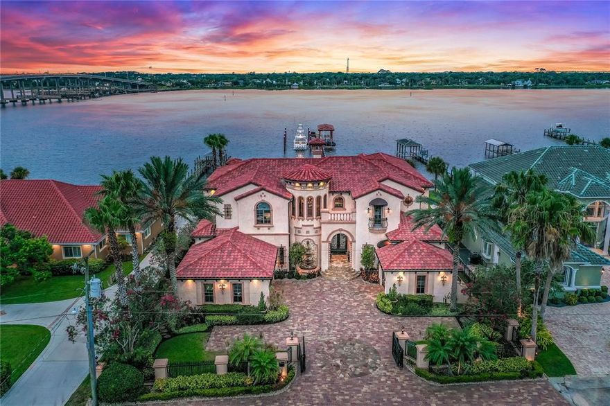 Boat lover’s paradise awaits at this Ormond Beach home on the Halifax intracoastal waterway. Over 300 ft of dock space with covered pilings, 2 boat lifts, a double jet ski lift, and a deep-water slip that can hold over a 70’ yacht. Dock is made of IPE, the finest quality wood decking, so it is beautiful and low maintenance. No expense was spared in the details of this home. The surround sound speakers extend throughout the house to the hidden rocks on the pool deck and under the dock, so you never miss a beat. The Elon entertainment system was recently updated to accommodate the entertainment, theater room, and security system.  A resort-style lanai overlooks the saltwater infinity pool with disappearing edge. The waterfall hot tub sits next to a private outdoor fireplace for ultimate privacy.
This custom-built home is perfect for entertaining. Past the gated entry and stone paver driveway you walk into dramatic ceilings and a curved staircase with Mediterranean flare. Wine room and bar extend to the dining room and butler pantry. Kitchen has been recently updated with tile and appliances. The Viking gas range is first-class. The double fridge/freezers are built in to match the detailed cabinetry. You will find beverage drawers in the island with granite breakfast nook attached. The walk-in pantry is every cook’s dream. Tons of storage and three dishwashers so you never miss a beat. 
The theater opens to a large upstairs game room with billiards and shuffleboard. The office has an executive built in desk and shelves. The downstairs master with a bathroom to feel like your personal spa. Double vanity and double walk in-closets. Hidden tv behind the vanity mirror. There are hurricane rated windows and shutters. An automatic generator that runs the full house will kick on as soon as the power is out. You cannot beat this location. You are right in the heart of historic Ormond Beach on a highly coveted John Anderson lot, just one block from Fortunato Park, The Casements, and a short walk to the beach.