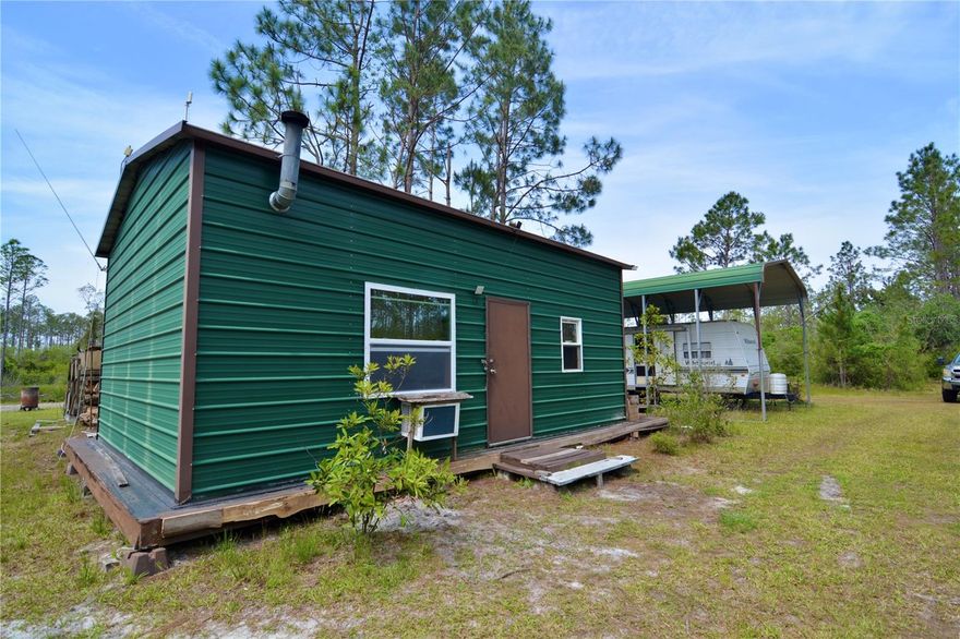 Located DEEP in the North Florida backwoods of San Pedro Bay, this unique offering includes two turnkey tracts of land, ready for immediate use as a hunting retreat or off-grid getaway. The 45.32-acre tract hosts a fully functional off-grid hunting camp—perfect for outdoor enthusiasts. The centerpiece is a metal-frame cabin offering approximately 780 sq ft of heated and cooled living space. Inside, you’ll find a two-bed loft, one bathroom, a well-equipped kitchen with propane appliances, and a cozy living area ideal for relaxing after a day in the woods. The cabin is cooled by two window-unit air conditioners and heated with a wood-burning stove. 
 
A screened-in porch offers a peaceful spot to enjoy the sights and sounds of nature, while an overwatch tower in the backyard provides a clear view of the game feeder to the north. 
 
Although off-grid, the cabin features two reliable power sources: a 10 KW military-grade diesel generator and a solar power system with backup batteries. Switching between systems is easy, thanks to a conveniently located transfer switch in the screened porch. 
 
Additionally, a fifth-wheel camper sits under a sturdy metal carport, fully connected to power, well, and septic. It’s always ready for visiting hunters or extra guests looking to experience this remote slice of paradise.