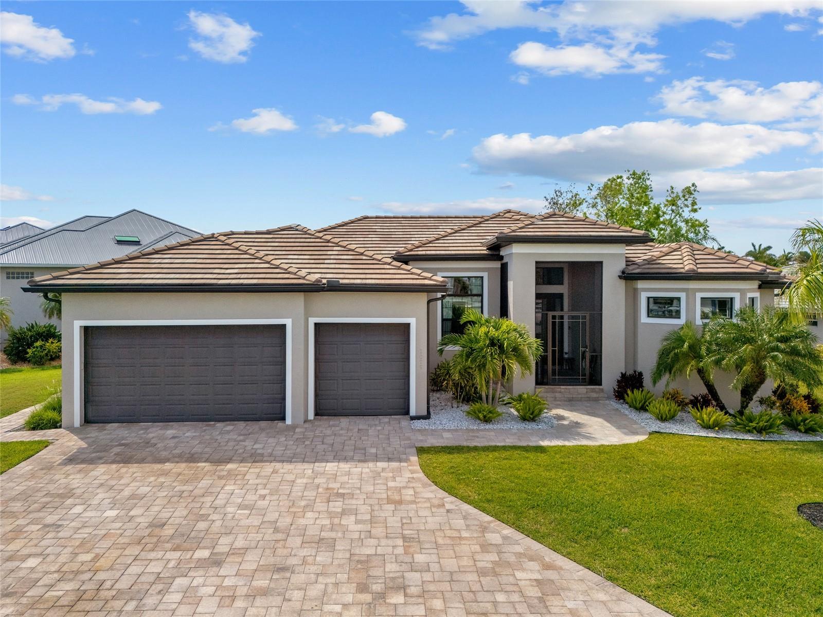 TURNKEY, modern luxury and practical design in this exceptional waterfront home located in the coveted Punta Gorda Isles! Minutes to Charlotte Harbor, this remarkable property is ideal for those seeking the ultimate waterfront lifestyle or a ready investment opportunity. With direct water access and proximity to the harbor, it's a boater's dream come true, while the screened-in saltwater pool offers a tranquil setting perfect for enjoying sunsets. Constructed in 2019, this residence features 3 generously sized bedrooms with custom walk-in closets and 2 elegantly updated bathrooms with premium finishes. Encompassing 2,029 square feet of expertly crafted living space, the open floor plan effortlessly connects the indoor and outdoor areas through pocket sliders that lead to a spacious lanai. The master suite is a deluxe, complete with a spacious spa shower, soaking tub, and refined details throughout. Recent upgrades include new carpeting throughout, maintaining a shoe-free environment, a cutting-edge water purification system, and a UV air filtration system for superior air quality. The back lanai features high-grade Cat 5 hurricane-rated screening, complementing the front screened-in patio for enhanced outdoor living. Additional improvements include new appliances, a saltwater softener system, a heated saltwater pool system for year-round use, and a newly installed central AC system, along with a cooling unit in the three-car garage. Every element of this property has custom lighting, door hardware, faucets, and fixtures, ensuring both style and functionality. Its contemporary design stands out in the area for its storm resilience, elevated construction, stem walls along the canal, and hurricane-rated windows, doors, and pool screens. Fully furnished with exquisitely selected luxury pieces from Anthropologie, Pottery Barn, Sleep Number, and Modern Living. This home is a true masterpiece with its flawless craftsmanship, prime location, and grand finishes. Whether you're in search of a permanent Florida sanctuary or a high-end investment property, this home offers everything you desire. Don't miss this opportunity! Schedule your private showing today!