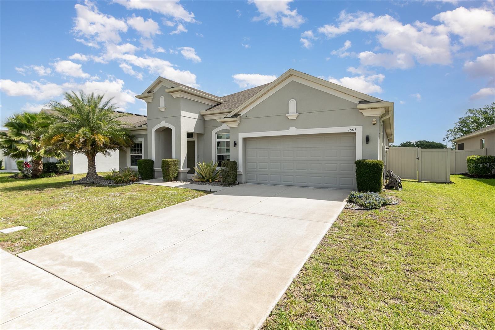 One or more photo(s) has been virtually staged. Say hello to your 2020 built home in Lancaster Park! With 4 bedrooms plus an office, 3.5 bathrooms, two living rooms, and 2,932sqft, this home has all the space you need! The home’s two primary suites and its split floor plan make it perfect for multi-generational living. As you approach the property, you will spot the community pool and playground on your way to the elongated driveway leading to your oversized two-car garage. Entering through the front door, you are greeted by update luxury vinyl plank flooring that extends throughout all living spaces and bedrooms, and a formal sitting room and half bathroom to your right. To your left are two guest bedrooms and a guest bathroom. The bedrooms in the home have upgraded window treatments with custom-fit, black-out curtains, and the bathrooms have tall quartz-topped vanities. Moving along into the kitchen, the open floor plan is on full display and the 9’4” ceilings let natural light bounce through the home. Your massive kitchen island is stunning and perfect for entertaining. The kitchen is also equipped with a walk-in pantry, stainless steel appliances, 42” cabinets with crown molding, subway tile backsplash, and brushed gold fixtures. The kitchen continues into the formal dining room which is basking in natural light. Around the corner you will find the spacious laundry room with upper cabinets for easy storage and plumbing in place and ready for a utility sink. The garage is right nearby through the mudroom/drop zone and has space for two cars plus a golf cart or bike storage! Back inside, the office is tucked behind the living room and next to the dining room. The living room has tray ceilings, built in floating bookshelves with recessed lighting, and looks out into the backyard. The set of three sliding glass doors are stackable for perfect indoor-outdoor living. Stepping out onto the lanai, you will notice the generous size of the screened-in space and its two outdoor ceiling fans. Beyond the lanai is plenty of yard space which has been fully fenced with beige vinyl panels. Also overlooking the backyard are the two primary suites. The larger of which is on the north end of the home and is sure to impress with its high ceilings and massive en suite bathroom. The primary bath has a large soaking tub, walk in shower, private water closet, and wide, split vanities. Your walk-in closet has lovely built-in shelving and drawers as does the second primary bedroom’s closet. Across the living room you will find said smaller primary suite which has a walk-in closet and en suite bath. Other notable features of the home include double pane windows, gutters along the entire permitter of the property, an alarm system with cameras, and contemporary light fixtures throughout the home. When it comes to location, you are in one of the top growing areas of central Florida! You are 30 miles from Disney and the theme parks, 35 minutes to Orlando International Airport, 25 minutes to Lake Nona and Medical City, 10 minutes to two premier golf courses, 5 minutes to grocery stores and shopping along 192, and ten minutes to gorgeous Lakefront Park on East Lake Toho. Come see this updated home today! **There is a floor plan and video tour of this property!