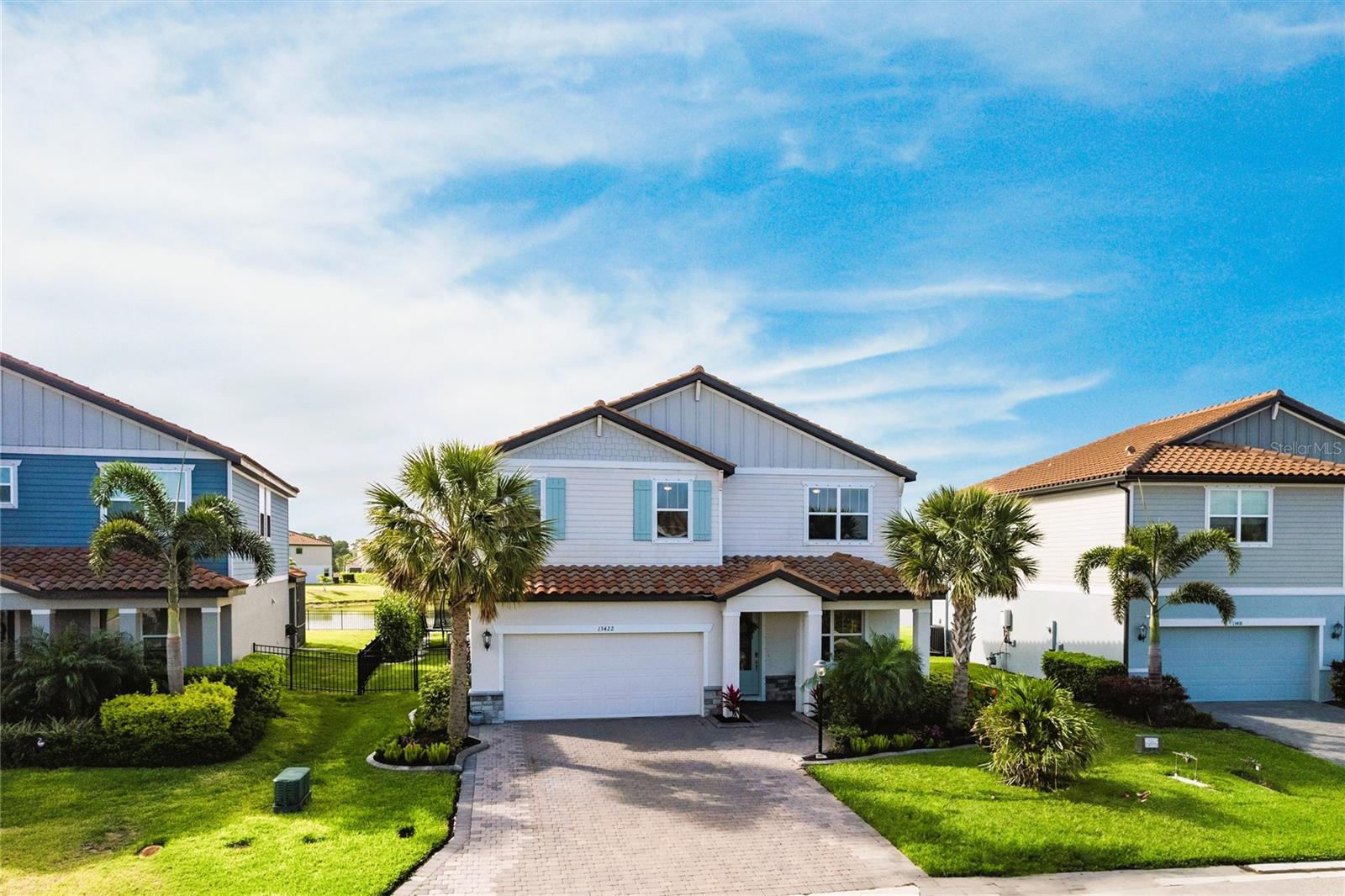 Stunning Sizable 4/3 New Home w/ Serene Water Views– Your Peaceful Florida Lifestyle Awaits! Welcome to Savanna at Lakewood Ranch – which has larger lots for more comfort and privacy, unbeatable water views, regular community activities, and amazing amenities. Located in the highly sought-after large pond, this immaculate 4-bedroom, 3-bath home offers the space and private lifestyle you’ve been dreaming of! From the moment you step through the front door, you’ll be captivated by the open-concept layout, built-in TV wall with storage and shelving, gorgeously landscaped front and back yard, aluminum fencing and larger trees for added privacy, and a breathtaking panoramic water view that serves as the backdrop to your everyday living. Whether you're enjoying your morning coffee on the lanai or entertaining guests in the spacious living area, the tranquil water vistas will never get old. The gourmet kitchen is a chef’s delight, boasting a double oven, quartz countertops, stainless steel appliances, a large island, a huge walk-in pantry and an abundance of cabinet space. The owner’s suite is a serene retreat featuring a massive walk-in closet and en-suite bathroom with dual vanities, and large walk-in shower. This home is move-in ready with fresh finishes, lush landscaping, and access to resort-style community amenities including a pool, playground, dog park, basketball court and walking trails. Homes with views like this don’t come around often. Don’t miss your chance to own a slice of paradise in one of the nation’s top-rated master-planned communities. Schedule your private showing today and come see for yourself!