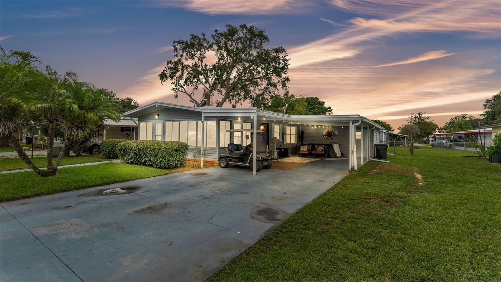 BACK ON MARKET----FINALLY!!! Here's the Turnkey Economic Home you've been looking for. And in case you're wondering, there is NO LOT RENT so you own the land. Located in the Highly Coveted Lake Mariana Acres Community where you can enjoy OPTIONAL Hoa amenities like the clubhouse and community Boat Ramp for just $50/year. Your next home is Newly Renovated. Boasting New Sub Floors, Flooring, New Light Fixtures and Ceiling Fans, Newer Tinted Windows, a Remodeled Kitchen, New Ac(2024) upgraded premium Tie Down straps in 2021 and a Corrugated Steel Roof. This Home has tons of character and is ready for its new owner. It is a 2 Bed/2 Bath plus Bonus room(Currently used as a 3rd bedroom) with plenty of Storage in the 18x16 Workshop and matching 12x8 Shed. Also Enjoy Golf Cart parking and a Cozy Swim Spa under your Oversized Carport while you let the Kids play in the Fenced in Backyard(Fur Babies included). Be enamored with the Tranquil view of Lake Mariana, known for its peaceful and recreational setting, while you take the boat out and/or Fish. This is the Functional retreat youve been looking for. Call today to book your Showing!!!