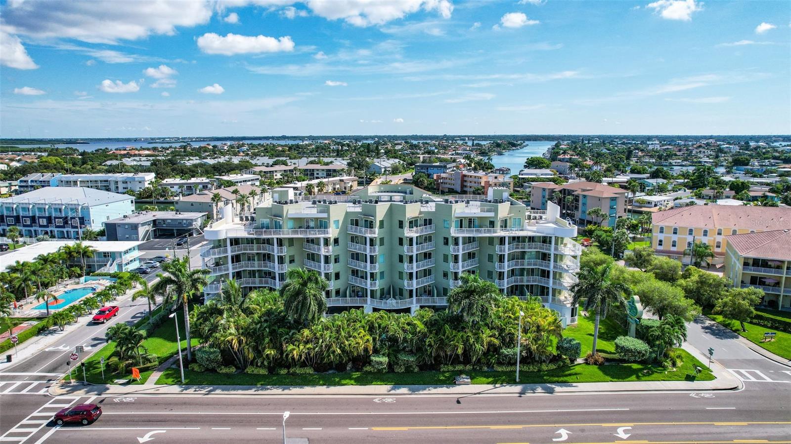 This well-maintained and turnkey 2br/2bth condo is sold fully furnished with updated paint, decor and a beautiful view of the ocean and tropical palms overlooking the community pool. This unit has one of the largest wrap-around balconies in the complex, being an end-unit with a direct gulf view from the 4th floor and an extra window inside the unit letting in an abundance of natural lighting. Brand new Trex Polywood lumber balcony table (July 2025). New shower floor installed July 2024. New Roku Smart TVs in living room and bedrooms. Stainless steel appliances, granite countertops, and washer dryer in unit. Balcony access from both living room and primary bedroom. Primary bedroom has king bed with en-suite and extra vanity sink. Second bedroom has a queen bed and is also an en-suite. Both bedrooms have luxury closet storage installed. Living room has queen pull-out sofa. There is an Owner's closet to hold personal belongings. Unit has 1 covered assigned parking space. The Crystal Palms complex has an outdoor heated pool and spa, and handicap friendly equipment to get into the water. The complex has beach access walkways to the beach across the street. Treasure Island is the ultimate vacation destination where you’ll enjoy beach views, sandy beach, and turquoise waters. Visit the nearby famous John’s Pass Village (about a mile away) where there’s something for everyone; fish, rent a jet ski, take a dolphin cruise, shop, grab a drink, enjoy ice cream, or eat at one of the many amazing restaurants and enjoy music. Enjoy this tropical beach condo for your own personal use (up to 90 days a year) and maximize it as a rental investment property! Crystal Palms allows for minimal 1-night stays to help maximize your rental investment. Estimated rental potential = $50-60k gross a year