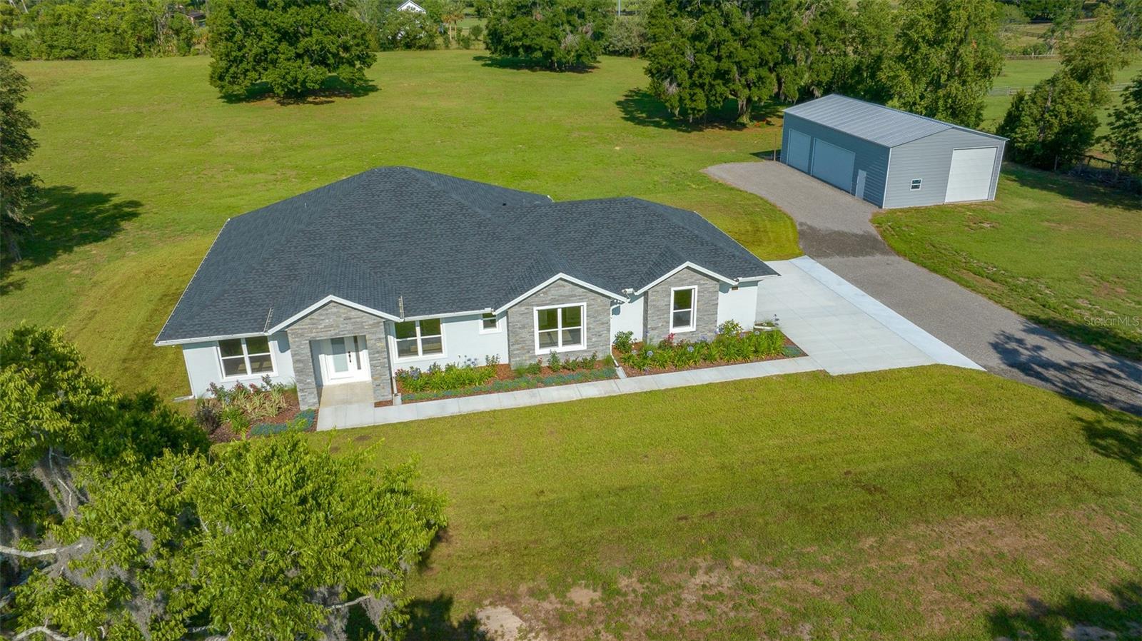 One or more photo(s) has been virtually staged. Modern Country Living on 5.7 Acres, room for a barn and paddocks or arena. Custom 4-Bedroom Home with a 30 x 52 Workshop
Experience the perfect blend of modern luxury and peaceful country living in this brand-new, custom-built 4-bedroom, 3-bathroom home, nestled on a spacious and fully usable 5.7-acre lot. Whether you're dreaming of a hobby farm or simply craving space and privacy, this property offers limitless potential.
Step inside to discover an open-concept layout designed for comfort and style. The chef’s kitchen features sleek quartz countertops with a matching backsplash, while energy-efficient LED lighting and an electric fireplace create an inviting atmosphere. Oversized ceiling fans with mounted remote controls ensure year-round comfort in every room.
Outdoors, the opportunities are endless. The lanai features a power screen that can be used to shield the sun and keep you safe from bugs. The level acreage is ideal for gardening, livestock, an outdoor pool area, barn or future expansions. A standout feature is the massive 30’ x 52’ workshop with soaring 14-foot ceilings—perfect for equipment storage, projects, or running a business from home. There are so many upgrades with new this construction info is attached.
Don’t miss your chance to own a move-in-ready property that truly has it all—modern amenities, expansive land, and endless possibilities.