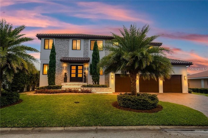 A spectacular custom waterfront estate with a clean California Modern design, this exceptional home stands out in one of St. Petersburg’s most sought-after neighborhoods. Built with an impressive level of detail and craftsmanship, it offers a rare combination of style, comfort, and functionality. Don't miss the video 1172020405 walk-thru at Vimeo. The front exterior makes a strong first impression with extensive stonework, a marble walkway, and custom composite wood Eden Coast 3-car garage doors. Inside, the open-concept layout is enhanced by 8-inch wide French oak flooring throughout and airy 10-foot ceilings. Just beyond the home office with custom built-ins, architectural columns with modern stone accents add character and definition to the main living space. The kitchen is thoughtfully designed with Cambria Britannica countertops, KitchenCraft cabinetry, Thermador appliances, and matte black finishes. An oversized walk-in pantry and butler’s pantry with a sink and wine refrigerator provide excellent prep and storage space. The large one-piece quartz island seats five comfortably, with additional room for dining in the breakfast area. The great room features wood ceiling beams, a striking stone accent wall, and built-in cabinetry with custom wood paneling that continues into the dining room ceiling, creating a cohesive and polished look. The first-floor primary suite offers water views and a private bath entered through custom barn doors. The bathroom includes floor-to-ceiling marble tile, a soaking tub, a large walk-in shower, and matte black fixtures. The spacious 16.5' x 7' walk-in closet is paired with a private laundry room in the suite, and there is an additional laundry room upstairs. Motorized blinds add everyday convenience throughout the home. Upstairs, the custom oak staircase with open risers, iron railing, and statement chandelier leads to a large loft area. Through the 8-foot sliders, the balcony offers beautiful Tampa Bay views along with marble flooring and wood-beamed ceilings. The second level also includes four oversized bedrooms with French oak flooring and three full bathrooms finished with marble floors, designer tile, and quartz countertops. The outdoor living area is equally well designed. Hurricane-rated 8-foot sliding doors open to a covered outdoor kitchen with custom granite counters, weatherproof cabinetry, a 38-inch stainless Delta Heat grill with hood, and a beverage center with sink. The backyard is set up for year-round enjoyment with a gas-heated pool and spa, tumbled marble decking, and a seating area centered around a fire table activated at the push of a button. For boating, the property offers custom dockage and a high-speed lift capable of handling a vessel up to 24,000 pounds, with access to sailboat water. The Synlawn artificial turf backyard includes a putting green and offers a low-maintenance alternative to natural grass. Additional features include a Sonos sound system and generator-ready wiring. Homes with this level of finish and attention to detail rarely become available. This is a unique opportunity to own a custom waterfront residence in a premier St. Petersburg location. Photography, renderings, floor plans, descriptions, current furnishings, dimensions, square footage, and features are approximate, for illustrative purposes only, and subject to change without notice. Buyer to verify all information through personal inspection. Equal Housing Opportunity.