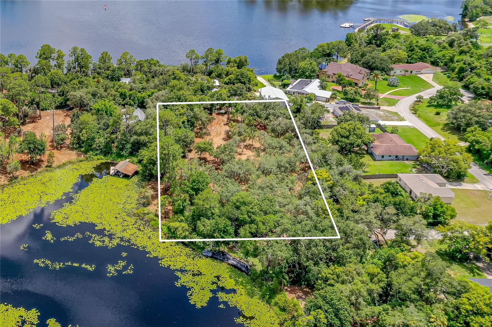 Nestled beneath a hammock of cascading Oak and Pine trees, this 1.4 acres of lakefront property offers the rare opportunity to create a dream oasis on a piece of pure Florida ground. With picturesque views of McGarity Lake, this is an outdoorsman's paradise to build a dream vacation or forever home. Situated at the end of a well-maintained dirt road with utilities nearby. An adjoining parcel (V4939451) of 9.4 (2.9 dry) acres can be combined to total 4.3 acres of buildable uplands. Don't miss out on the chance to own a piece of old Florida!
