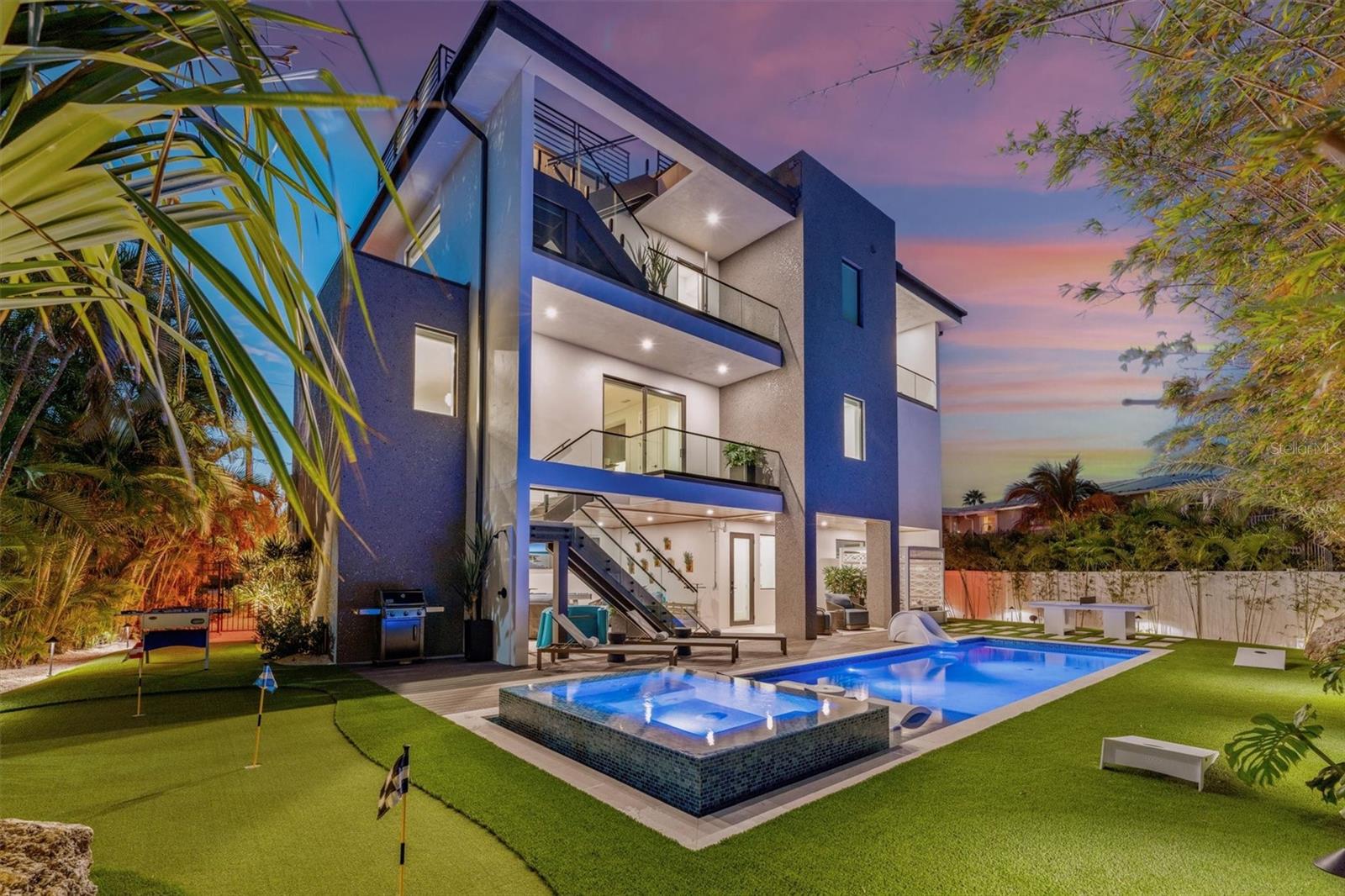 Sunset Reflections is an organically warm modern luxury home that represents the finest AMI has to offer. From here, your views of the gulf are extraordinary and your walk to the powder white sand of Bean Point is incredibly short. This AMI paradise encompasses solid block construction, poured concrete terraces, a $15k solid mahogany front door and an over $300k Restoration Hardware furniture and art package. This home will have you feeling a 5-Star Resort has met AMI. The home includes over 2,850 sq ft, 4 bedrooms, 4.5 bathrooms, a spacious family room/kitchen/dining great area with a see-through fireplace in the middle, game room, over 3,000 sq ft of terrace and patio space and 2 garages, one double and one single and both include an epoxy finish. The views from this home are breathtaking and you are close enough to take in the sounds of the waves. From the spacious rooftop you can see nearly the entire northern end of AMI including the Skyway bridge from the bay as well as expansive views of the gulf. The 4th level rooftop includes a 6-seat hot tub, wet bar including a sink, ice machine and fridge, outdoor bed, lounge area with a large concrete firepit and dining table for 8. The views from 3rd level terrace just outside the two master bedrooms boost 800 sq ft of space with an outdoor bed for both bedrooms, furniture to relax in as well as an outdoor tub, all with spectacular gulf views. The downstairs back of house area includes a 40 ft. long pool/sun shelf/hot tub combo that is already furnished with ledge loungers, side table and umbrella. The saltwater pool also includes automation controls and multiple heaters, both gas and electric. The pool area also includes a water slide, daybed, 5-hole putting green complete with a sand trap, foosball, cornhole, ping pong, shuffleboard, three 75’’ TVs, patio wet bar with sink, ice machine and fridge, numerous floats, paddle boards, comfortable sitting areas and loungers. The rest of the outside area includes luscious landscaping, a fully premium turfed back yard, over 30 landscape lights and an outdoor speaker system. Inside you will find the most complete game room on the island as it includes a boat racing arcade game (Hydro), a shooting game (Revolution X), a multi-cade with over 3,000 games, a golf simulator (Golden Tee), a 5 ft. wide wall mounted scrabble board, multiple TVs as well a poker table. The three adult bedrooms have all been curated from Restoration Hardware designers and include deluxe mattresses from Tuft & Needle. The large 3rd floor master includes a shower and tub that include gulf views as well as a wet bar. The kids bedroom includes a bunk system with two twin beds and a staircase leading to a queen bed on the top. The kitchen includes top of line appliances such as sub-zero, wolf, a wine fridge and built-in coffee maker. Inside and out, much of the home includes a TerraNeo finish, which loosely translates as “New Earth”. It’s a high-performance, long-lasting, radiant finish that is composed of large mica chips and multi-colored quartz aggregates. The home includes over 20 audio speakers inside and out, with 6 different zones. The home is highly automated from your smart phone, i.e., control lights, cameras, climate and music. It’s ready for anything as it’s fully furnished down to the plates and silverware.