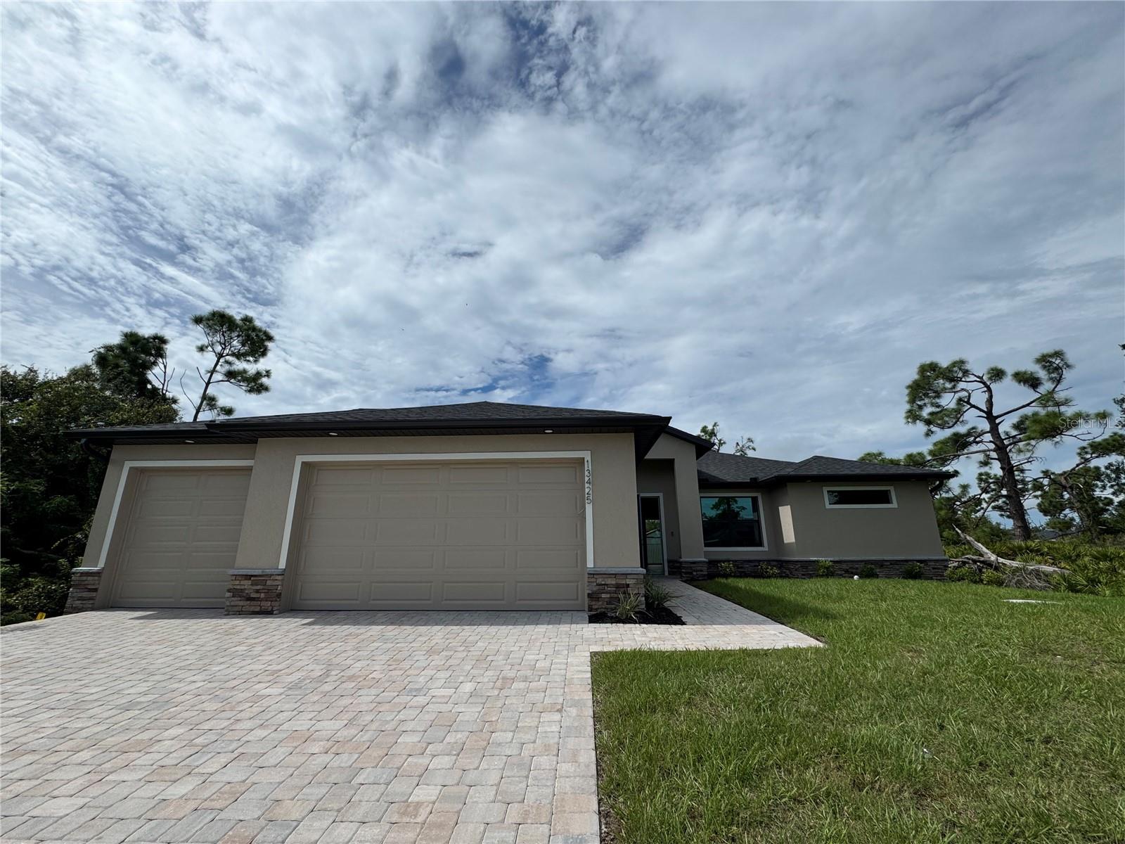 Be the first to live in this stunning new construction by Douglas Brooke Homes. This spacious 4-bedroom, 2-bathroom home features over over 1700 square feet of thoughtfully designed living space, complete with a 3-car garage and private pool.
Step inside to an open-concept floor plan with soaring ceilings and elegant wood-look tile throughout the main living areas. The great room flows seamlessly into a chef-inspired kitchen with quartz countertops, stainless steel appliances, a large center island, and a walk-in pantry. A vaulted-ceiling dining area sits just off the kitchen, overlooking the backyard and pool.
The primary suite offers dual walk-in closets and a spa-style bathroom with double vanities and a glass walk-in shower. Three additional bedrooms and a full guest bathroom provide plenty of room for family or visitors.
Enjoy peace of mind with impact-resistant windows and doors, a smart home system, in-wall pest control, and a pool alarm. The home also includes a spacious laundry room with sink and ample storage throughout.
Conveniently located near shopping, restaurants, hospitals, boat ramps, and more.