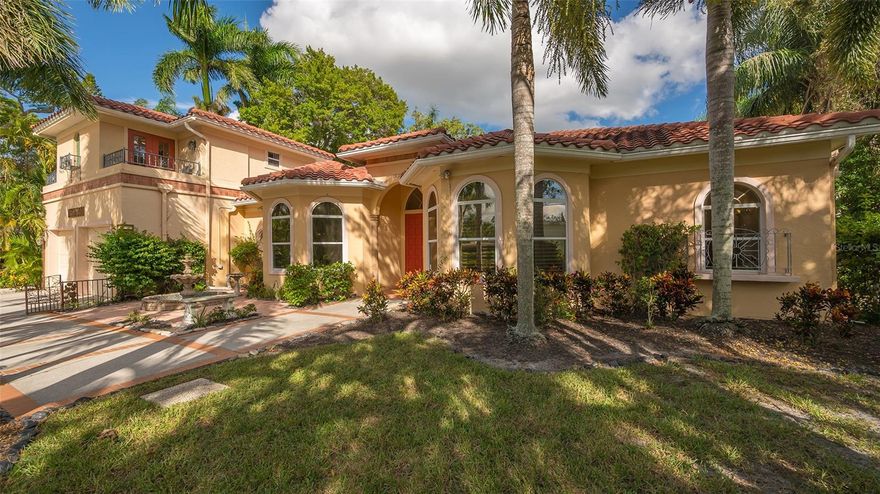 Opulent and ageless; this is a highly desirable West of Trail home location. Embrace the beauty of this spacious custom style pool home, updated in 2003. A covered foyer with double entry doors opens into a large formal living room with French doors and a view of a private 384 square foot in ground pool, and outdoor kitchen, under an elevated large screened enclosure.  The split bedroom floor plan features a ground level master suite, with an adjacent bonus office/nursery room. The formal living room and formal dining room are diagonally across from each other and the open plan, windows, and high ceilings throughout this home create expansive volume and space throughout. The hallway leads to the eat-in kitchen which has a large bar area that opens to the great room which has two sky lights, and a wood burning fireplace.  A pocket door entry off of the great room leads to a hallway with two additional bedrooms, a utility/laundry room with a closet and window, and a shared large pool bath with shower. Off of the kitchen and tucked away near the stairs, there is a powder room. The staircase, with entry access near the interior garage door leads to a separate second floor master bedroom suite with a kitchenette, and a full bath. The highlights of this property include a highly desirable location within two blocks to Sarasota Bay, close proximity to Southside Village, Southside Elementary School and Sarasota Memorial Hospital. New concrete tile roof in 2016, and a new 16 seer heat pump A/C installed in 2022. The kitchen and bathrooms have granite countertops. The kitchen has stainless steel appliances and a wet bar. There are minor maintenance items that Buyer will want to address after closing. Property is being sold “As Is”.