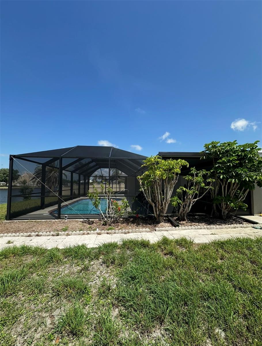 ELEGANTLY MAINTAINED POOL HOME JUST A BLOCK AWAY FROM CHARLOTTE HARBOR AND SUNSEEKER RESORT. This residence features a beautifully updated open floor plan, enhanced by an abundance of sliding glass doors that invite natural light, creating an atmosphere conducive to both comfort and elegant entertaining. The spacious kitchen is a culinary enthusiast's dream, offering ample counter space, a generous pantry, a breakfast bar, and a formal dining area.
The living areas are designed for relaxation and enjoyment, featuring ample space for furnishings and leisure activities. The expansive master suite includes direct access to the lanai, along with a master bathroom.
Indulge in the sun on the expansive screened lanai, complete with a pool, or take a leisurely stroll to the waterfront where you can dock your boat at your private dock. Please note that this property is not furnished.