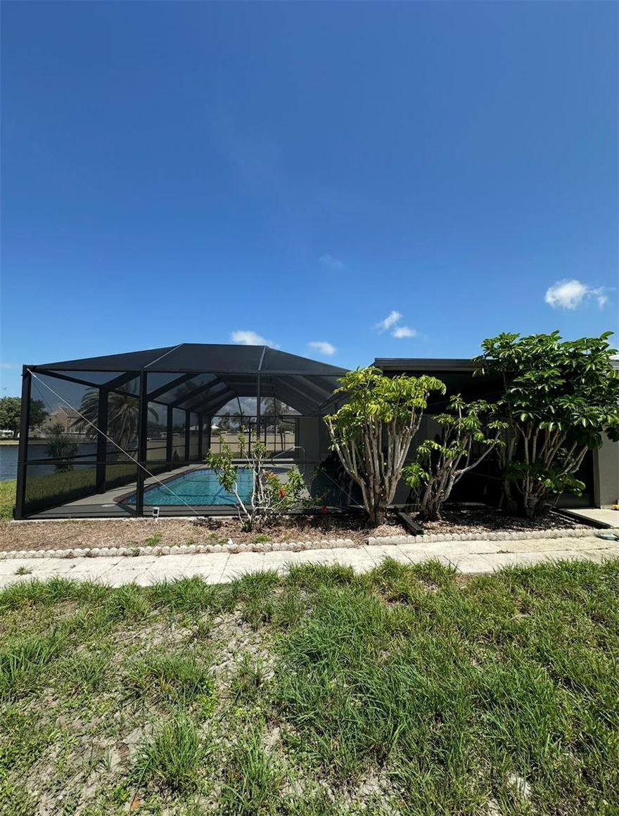 ELEGANTLY MAINTAINED POOL HOME JUST A BLOCK AWAY FROM CHARLOTTE HARBOR AND SUNSEEKER RESORT. This residence features a beautifully updated open floor plan, enhanced by an abundance of sliding glass doors that invite natural light, creating an atmosphere conducive to both comfort and elegant entertaining. The spacious kitchen is a culinary enthusiast's dream, offering ample counter space, a generous pantry, a breakfast bar, and a formal dining area.
The living areas are designed for relaxation and enjoyment, featuring ample space for furnishings and leisure activities. The expansive master suite includes direct access to the lanai, along with a master bathroom.
Indulge in the sun on the expansive screened lanai, complete with a pool, or take a leisurely stroll to the waterfront where you can dock your boat at your private dock. Please note that this property is not furnished.