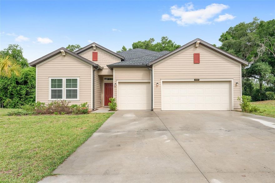 Located within Grand Park North, this Tivoli model was built for the kind of Florida living people move here to find. With private access to Rainbow Springs included through the POA, days on the water are never far from home, whether that means kayaking the river, spending afternoons at the clubhouse pool after a workout in the fitness center, or walking the trails beneath the oaks. Downtown Dunnellon sits just five minutes away, offering local restaurants, small shops, and the easy pace that makes this part of Florida so loved. Inside, the home balances clean design with practical comfort. Ceramic tile runs throughout the main living spaces, while the split floor plan offers four bedrooms and three full baths, including a guest suite with its own en-suite bathroom for added privacy. The kitchen opens naturally into the living and dining areas, creating a space that feels connected without trying too hard. Out back, the epoxy-finished lanai extends the living space outdoors, while the three-car garage with individual bay doors and matching epoxy flooring adds both function and polish. This is a home that fits the lifestyle here; simple, comfortable, and centered around the outdoors.