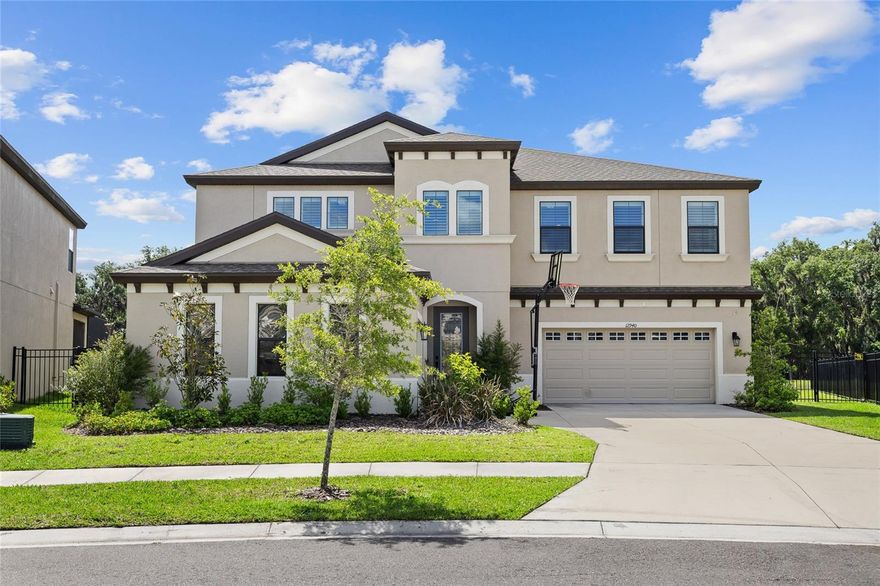 PRIVATE POOL & SPA HOME! WATER VIEW! This extraordinary home features 5 bedrooms, 4 and a half bathrooms, and a 3-car garage. Located in the Hawkstone Community, this 2022 built home has so much to offer. The exterior has great curb appeal with a separate side entry 1-car garage in addition to a full 2-car garage. Inside the home, is an open foyer with soaring ceilings, an elegant chandelier, and a grand staircase. WOOD TILE FLOORS THROUGHOUT! There is an office and formal dining room near the entry way and a convenient downstairs half bathroom. The kitchen has it ALL, with features including a center Island with extended seating, modern stainless-steel appliances with a gas cooktop and built-in oven, stainless range hood, farmhouse sink, cabinetry with crown molding and fully extended past the breakfast nook, stone countertops, tiled backsplash, and a walk-in pantry! The kitchen overlooks the family room for an open concept living space, perfect for entertaining guests. There is a private guest suite with it's own bathroom for extra privacy. The second floor has a BONUS ROOM AND UPSTAIRS BALCONY, for endless possibilities, as well as the remaining bedrooms and bathrooms, two joined with a jack and jill bathroom and the 4th bedrooms with an additional full bathroom. The primary suite has a spacious ensuite bathroom with two separate vanities with sinks, separate tiled garden tub & fully tiled walk-in shower, plus an OVERSIZED WALK-IN CLOSET. The backyard is your own private oasis with a HEATED POOL & SPA BUILT IN 2023, fully caged with the screened in lanai, overlooking a beautiful pond view to really enjoy those Florida sunsets, and with a spacious fenced in yard! NO REAR NEIGHBORS! The Hawkstone community has so much to offer, a dog park, two pools, playgrounds, sports courts, trails, and a dock! Your opportunity awaits! Call today to schedule your private viewing!