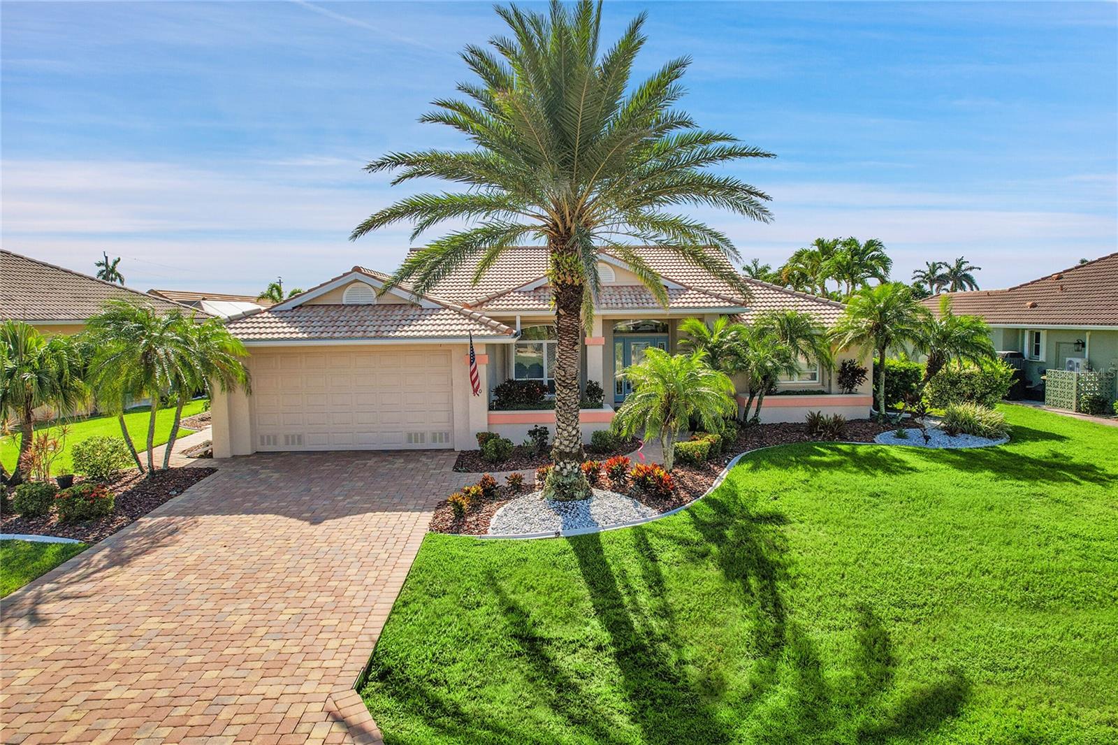 ESCAPE TO YOUR WATERFRONT DREAM HOME IN PUNTA GORDA ISLES! This beautifully updated 3 Bedroom, 2 ½ Bath, Open Floorplan Home offers a light, airy and welcoming atmosphere. The stunning Gourmet Kitchen, remodeled in 2023, offers light Granite countertops with the matching Granite backsplash, pot filler, new light, wood soft-close cabinets, upscale appliances including the Bosch stainless steel refrigerator (2023), Bosch dishwasher, and a professional Koolmore stainless steel convection electric oven with a five burner-ceramic glass cooktop (2023). The large granite island accommodates seating and includes a built-in stainless steel wine cooler. The open floorplan provides a casual eating area near the kitchen which flows into the Great Room. The formal dining area is perfect for family dinners and holiday celebrations. For added convenience, the newly added half bath/laundry area is ideal for visitors while still allowing privacy for overnight guest areas. A separate living area has French doors that lead to the covered lanai allowing you to step out to your private lanai from the Kitchen, Great Room, or the Primary bedroom! Upscale, custom plantation shutters highlight luxury in this home with gleaming wood laminate floors flowing throughout the main living areas. New carpeting (2025) in the Primary Suite and a newly remodeled (2023) Primary En-suite Bathroom with Stone and Granite in the Roman shower, Granite countertops with double sinks. This home also offers two spacious guest bedrooms and a full bathroom which can be closed off for privacy by a pocket door. The new half bathroom with laundry and custom cabinet was added in 2023. Enjoy the gorgeous, heated pool and the separate free-standing hot tub surrounded by the paver brick deck and enclosed with a well-maintained pool cage. The home also offers a large dock and a boatlift with a 13,000 lb capacity, just 10 minutes to Charlotte Harbor and open water. It's conveniently located only 3 short blocks to Fishermans Village and the popular dog park, as well as a short distance to St. Andrews Golf Course, Pickleball at Gilchrist Park and other parks. Enjoy easy access to I-75, historic downtown Punta Gorda, restaurants, shopping, boating, and a short trip to gorgeous beaches. Don’t miss this opportunity to own this well-maintained, updated coastal home in the perfect location in Southwest Florida!