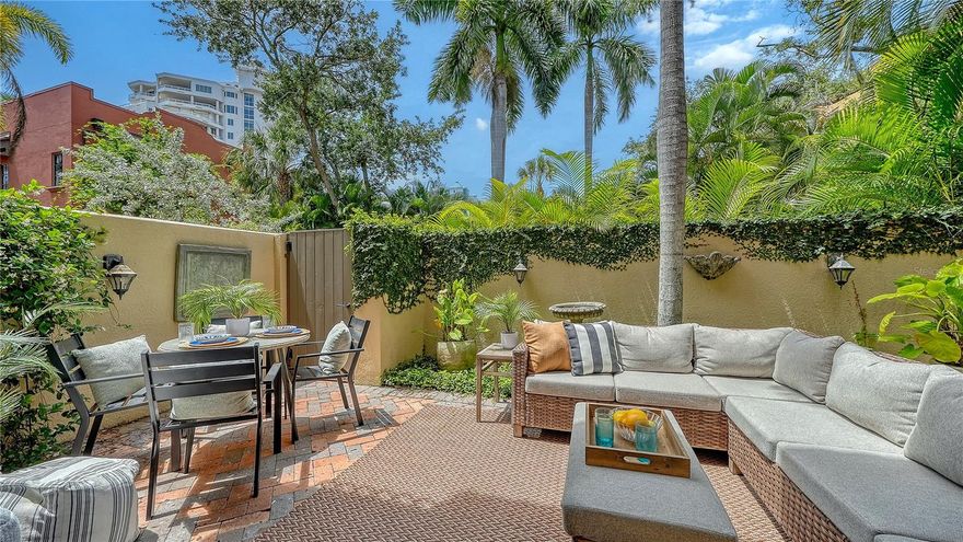 Brand-new staged furnishings, available for purchase separately, elevate this beautifully updated Burns Court Villas residence into an ideal move-in-ready downtown Sarasota retreat. Located in the heart of Sarasota’s iconic Burns Court district, this two-story, three-bedroom residence blends the privacy and comfort of single-family living with the walkability, charm, and energy of downtown just outside your door. 
Spanning nearly 2,000 square feet, the thoughtfully designed layout is enhanced by multiple outdoor living spaces, including the largest private courtyard in the community and three separate bedroom balconies. Beyond the solid mahogany front door, refined interiors showcase travertine flooring, crown molding, high ceilings, impact-rated windows and doors, and an abundance of natural light throughout.
The main level is designed for effortless everyday living and entertaining, flowing seamlessly from the formal living room—anchored by a gas fireplace and custom built-ins—to the dining area and sunlit family room overlooking the lush courtyard. The 2023-remodeled gourmet kitchen is appointed with custom wood cabinetry featuring soft-close drawers and pull-out storage, under-cabinet lighting, thick quartz countertops, and an oversized island with seating. Premium appliances include a Sub-Zero refrigerator, Viking gas range and hood, and Miele dishwasher, while upgraded LED lighting enhances both ambiance and functionality. 
Upstairs, Brazilian cherry engineered hardwood flooring leads to a serene primary suite featuring a private balcony, custom walk-in closet, and a fully renovated en-suite bath completed in 2025 with dual quartz-topped vanities, a tile-and-glass walk-in shower with bench seating, and a dedicated makeup area. Two additional guest bedrooms—each with its own balcony—share a beautifully updated bath with designer finishes. A second-floor laundry room with additional storage cabinetry adds convenience.
Burns Court Villas is known for its tranquil, tucked-away atmosphere in the center of downtown Sarasota, offering covered trellised walkways, lush tropical landscaping, peaceful fountains, and charming courtyard spaces that create a uniquely serene residential setting. Residents enjoy a heated pool and spa, lounge area with outdoor fireplace, secure parking, fob-access gates, and enhanced perimeter security. The association also covers many utilities and services, including management, grounds maintenance, pest control, water, sewer, and waste collection. 
Perfectly positioned moments from downtown Sarasota’s Cultural Coast, this residence places you near Marina Jack, the Bayfront, theaters, galleries, farmers markets, boutique shopping, and acclaimed dining along Main Street. St. Armands Circle, Lido Beach, and Sarasota’s Gulf beaches are just minutes away, creating an exceptional opportunity to enjoy refined downtown living paired with Sarasota’s celebrated coastal lifestyle.