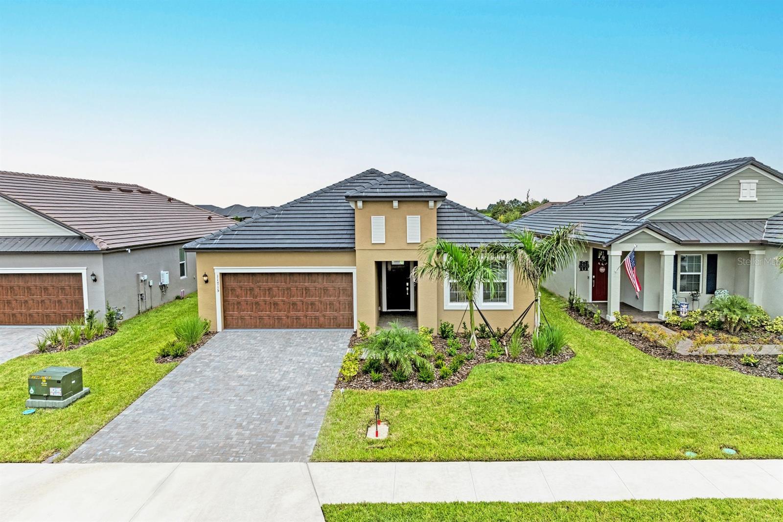Built in 2025 – LIKE NEW! This meticulously maintained waterfront home, in Prosperity Lakes Active Adult Lifestyle section, is dedicated to the 55+ community. Here you will find the Sunbrust floor plan, offering plenty of space to roam around in nearly 2,000 square feet featuring two bedrooms, two baths, flex room, and an extended lanai with serene water views. Upon entering, the double foyer leads to the spacious great room that connects beautifully to the whole home. The chef’s kitchen is a true centerpiece, featuring stainless steel appliances, a spacious walk-in pantry, quartz countertops and natural gas for cooking highlighted by an oversized island that offers both additional seating and ample prep space. The tucked-away dining area features two windows that allow natural light to stream in, while the contemporary family room opens to an extended L-shaped screened-in lanai through sliding glass doors—offering peaceful water views, perfect for relaxing or entertaining. The spacious owner’s suite offers large windows overlooking the pond, a ceiling fan, and a generous en-suite bathroom with walk-in shower and large walk-in closet. The guest bedroom is situated in the front of the home for added privacy. The flex room is located near the guest bedroom ideally for a home office, hobby room, or can be converted into a third bedroom by adding privacy doors and a closet. Additional highlights include a paver driveway, a durable, long-lasting flat tile roof, a large laundry room with ample space, tile flooring in main living areas and carpeting in bedrooms, drop zone near the garage entry, and a whole-house water filtration system. Upon completion, residents will enjoy access to two amenity centers, one exclusively for the 55+ community that is nearing its completion with a resort style pool, grand clubhouse, fitness center, playground, or for immediate use there is an outdoor fitness station and tennis court. Other amenities include hiking trails and future plans for sports courts and additional recreational facilities. Ideally located near Fort Hamer Park, Little Manatee River State Park, premier Golf courses and convenient access to I-75 and I-275 for easy travel to Sarasota, Tampa or St. Petersburg, beaches and airports, this home offers the perfect blend of comfort, convenience, and community living.