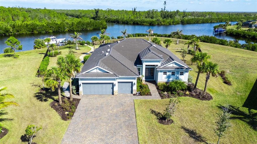 This home is a true gem in South Gulf Cove! Nestled on the largest lot in Harbor West, situated on over one acre, it has sailboat water access, making it a boater's paradise. Built in 2021, this unique Lennar built Sunset model is located in the exclusive, gated community of Harbor West, the only master-planned and gated community in South Gulf Cove. The home boasts a coastal design with 3 bedrooms, 3 bathrooms, and a den that can serve as a fourth bedroom. With 275 feet of water frontage, the property features a 90-foot extended paver walkway leading to a 14,000 lb boat lift and a maintenance-free composite dock. Inside, the formal foyer opens to a spacious living room with a custom-built entertainment center and electric fireplace. The kitchen is a chef's delight, with solid wood 42” cabinets, a built-in oven and microwave, an electric cooktop, a pot filler, a vented hood, and a farmhouse sink. The large center island with quartz countertops and bar seating connects to the breakfast nook with a picture window. The luxurious owner's suite includes tray ceilings, his and her walk-in closets, dual vanities, quartz counters, and an oversized tiled shower, with direct access to the lanai and pool area. The laundry room is equipped with wood cabinets, a utility sink, and sleek barn doors. Outdoor living is a dream with panoramic water views, a clear view lanai screen, a heated saltwater pool and spa, and a fully equipped outdoor kitchen and bar. The home is packed with upgrades, including shiplap, board & batten, barn doors, 8’ interior doors, coffered ceilings, crown molding, and smart home readiness. Additional features include an irrigation system, security camera system, tile roof, outdoor paved fire pit, and aluminum pergola. Live the extraordinary coastal lifestyle in this gated community with access to over 55 miles of boatable waterways. Enjoy the privacy and fabulous Florida weather. Port Charlotte offers some of the best swimming, boating, kayaking, and fishing in Southwest Florida. Your tropical oasis awaits!