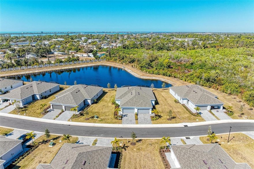 EXTENSIVE UPDATES! MOVE-IN READY!! This lakefront villa is located in Island Lakes at Coco Bay, a master-planned community just minutes from ENGLEWOOD BEACH. The property is in an X flood zone, so no flood insurance is required. This single-level Magnolia floor plan offers three bedrooms and two bathrooms.

A newly SCREENED front door enclosure welcomes you into the open layout featuring tile flooring, fresh paint, and high ceilings. The kitchen is bright and functional with QUARTZ countertops, a newly tiled BACKSPLASH, STAINLESS STEEL appliances, ample cabinetry, and a NEW dishwasher. A NEW washer and dryer are also included.

The private owner’s suite includes an en-suite bathroom. Two additional bedrooms and a full bathroom are located at the front of the home. PLANTATION SHUTTERS and TINTED, IMPACT-RESISTANT windows and doors. NEW CEILING FANS, FAUCETS, and CROWN MOLDING, UPDATED LIGHTING, and freshly painted grout complete the finished look. A NEW WATER SOFTENER system has also been installed.

Enjoy lake views from the extended lanai with a 2025 EPOXY finish. The two-car garage offers extra depth, insulated and vented doors, a 2025 EPOXY floor, and insulated attic space. GUTTERS have been added, and the paver driveway was sealed in 2025.

The HOA includes lawn care, landscaping, irrigation, and high-speed internet. Community amenities include a heated resort-style pool, fitness center, pickleball courts, playground, and clubhouse.