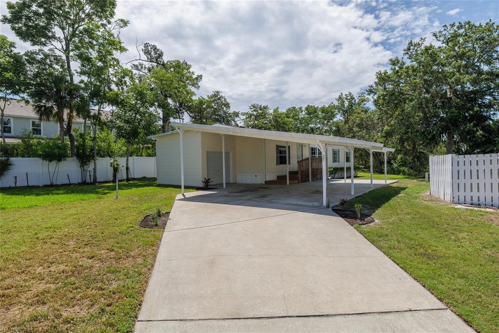 Back on the market Seller financing fell through -NO LOT RENT-Qualified buyers can assume the loan at a 3.125 percent interest rate! Spacious Lakefront Living, Fully Furnished and Move-In Ready! This large 3-bedroom, 2-bathroom home with a bonus room offers a bright, open floor plan with plenty of space to relax and entertain. Sitting high and dry on a perfect size lot in a quiet cul-de-sac. Enjoy peace of mind with a brand-new roof, a/c 2018 and take advantage of the rare 4-car carport and attached small garage, offering ample room storage or a workshop. Located just a short drive to the beach, shopping, and dining, this home combines the serenity of lakeside living with unbeatable convenience. Whether you're looking for a primary residence, vacation getaway, or investment opportunity this is it. Cash or Conventional Financing.