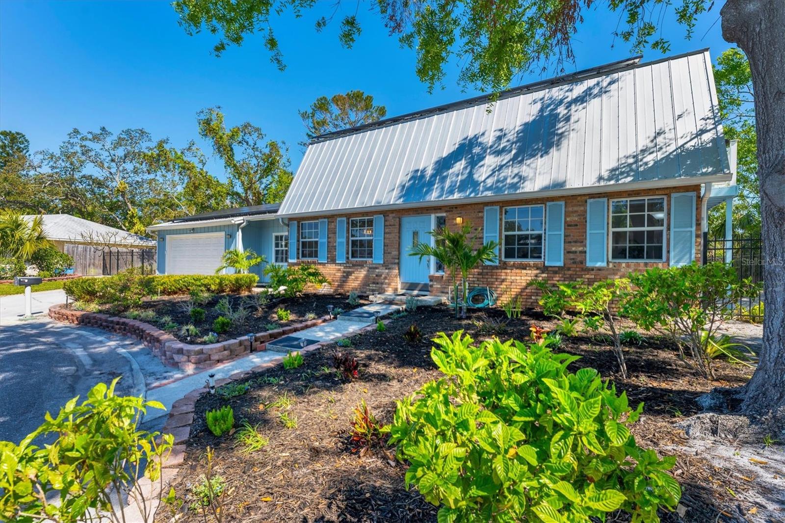 Every once in a while something special comes along and this home is that SPECIAL SOMETHING!  Located on a private cul-de-sac, with no through traffic, in a non-deed restricted neighborhood where you have room to park your boat or RV, this Cape Cod style brick home will surely capture your heart when you walk in the front door.  With a spacious 2544 sf of living area that includes a formal living room and dining room, a family room, a study, 3 bedrooms with 3 walk in closets, 2 bathrooms, a 24 x 6 indoor laundry room and a 2 car garage you'll have a perfect floor plan. Venture outside to the newer $100K+ caged heated saltwater swimming pool with fiber optic lighting and a covered lanai and here you have it all! This property is extraordinary with the privacy it affords.  The greenbelt bordering the East provides you with Florida's natural landscape affording you additional privacy. The owners have meticulously cared for this home with over $150K of upgrades that will be yours to cherish and enjoy.  Interior features showcase textured ceilings, luxury vinyl plank flooring, 2nd story bedroom balcony, wainscoting, French doors, coffered ceiling, kitchen up-lighting, a new 2025 refrigerator-microwave and stove on order, granite countertops, wood cabinetry, large pantry closet, farmers sink overlooking the pool, Levelor automatic shades with remotes, updated bathrooms with quartz counters, a primary bathroom showcasing beautiful herringbone tile work, under stair storage perfect for your Christmas tree so you can roll it out all decorated and a wood burning fireplace for added ambiance set in a backdrop of custom built in cabinetry in the family room.  The exterior has a plethora of features ranging from the firepit seating area, wood beam ceiling, Decocrete patio flooring with lifetime warranty, solar panels that are fully paid for where your power bills will range around $270/month, a covered patio with a 2022 newer hot tub, 2018 garage door, built in brick bbq grill that is heat adjustable, a patio tv, a fenced back yard, a front yard sprinkler system, $6K new added insulation, a new control panel box, a 2016 metal roof and a 2012 & 2018 A/C ...this home is truly loaded with extras!  This Northwest beauty is a hop, skip and jump to the 59th Street boat ramp where you can cruise to your heart's content.  Enjoy the area amenities with Robinson's Preserve, Geraldson's Farm, the Palma Sola Botanical Gardens and the DeSoto National Park.  Life just doesn't get any better than this!