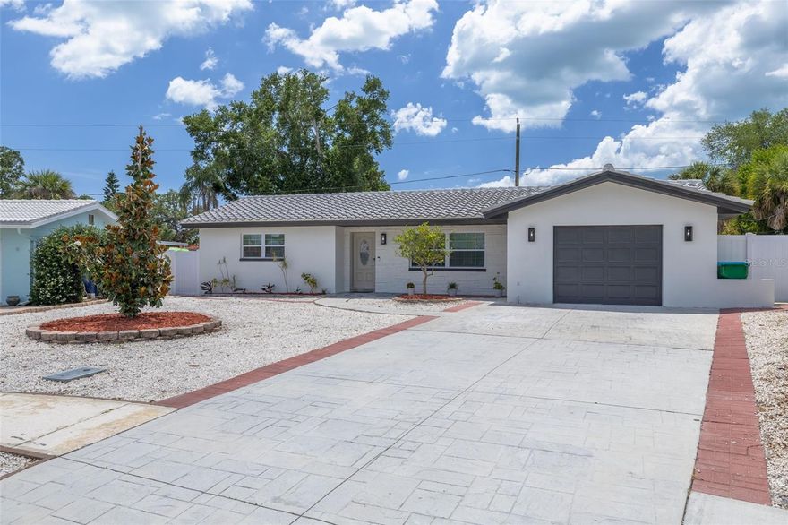 Discover elevated living in the heart of Seminole with this beautifully renovated 3-bedroom, 2-bathroom 1-car garage home offering luxury living and top-tier owner upgrades. Located on a quiet cul-de-sac in a highly desirable A-rated School District, just  minutes from the Gulf Beaches, Seminole Mall and fine dining. Nothing has been spared, every detail of this home has been carefully designed and ready for buyers with high expectations. Step inside to a wide Open Floor Plan featuring luxury waterproof vinyl flooring throughout, fresh interior and exterior paint and a modern electric fireplace that creates a warm and inviting atmosphere. You will fall in love with Brand New Dream Kitchen with Quartz Countertops, top-of -the -line appliances and a Smart Hub touchscreen refrigerator, making it perfect for entertaining and daily living. Upgraded modern light fixtures elevate the overall aesthetic of the home, making it stand out. Designed with privacy in mind, the spacious primary bedroom and en-suite bathroom are thoughtfully situated on the opposite side of the home from the other two bedrooms. Both bathrooms have been fully updated with luxury tile work, new modern vanities, double sink in the guest bathroom, and upscale finishes. The dining area opens up to a double glass door that leads to a peaceful backyard porch - ideal for your morning coffee. Enjoy the Fully Fenced Backyard for privacy, fresh green grass, additional Storage Shed and Well Sprinkler System. Newly paved double driveway. Washer /Dryer Hookup in Garage. Major Updates include New Clay Tiled Roof 2025, Newer Windows, AC unit 2021, Water Heater 2023. This home is equipped with Natural Gas Heat , Water Heater and Gas Stove. This home truly has it all - modern upgrades, thoughtful design and unbeatable Seminole Location !Flood zone X , no Flood insurance required.