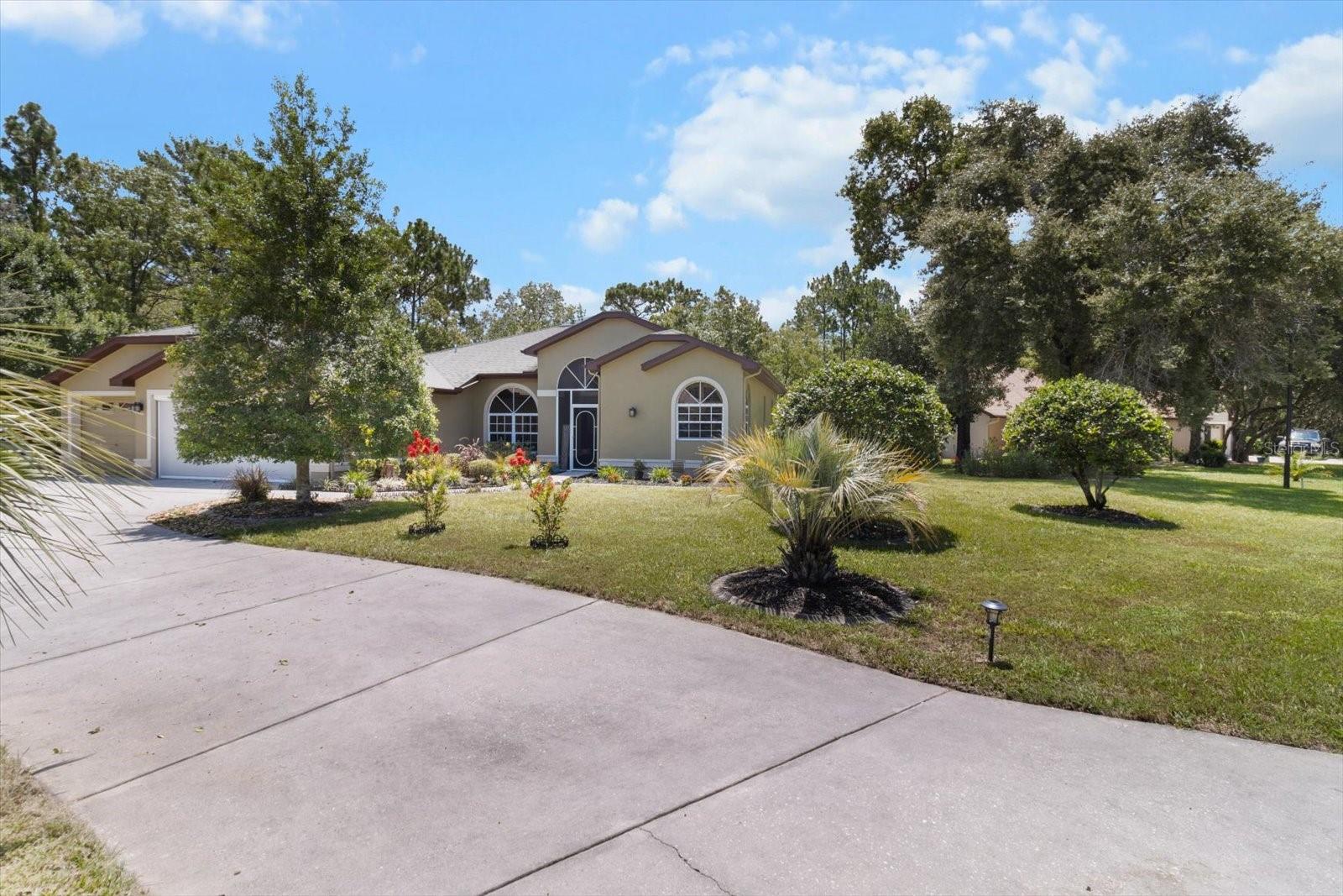 Charming Comfort in Sugarmill Woods – Stylish 3-Bedroom Home with Lanai & Upgrades! Welcome to One Plumbago Dr., Homosassa, FL 34446, nestled in the highly desirable Sugarmill Woods community! This thoughtfully maintained 3-bedroom, 2-bath home offers the perfect combination of elegance, efficiency, and Florida charm with 2,099 square feet of living space and a spacious 3-car garage. Step inside to a light-filled, open layout with granite countertops that bring a polished touch to the kitchen, paired with a brand-new dishwasher for modern convenience. Whether you’re cooking, entertaining, or enjoying a quiet morning coffee, this kitchen is designed to impress. The heart of the home flows seamlessly into a welcoming living space and out onto the beautiful lanai—the ideal spot to relax and unwind, surrounded by nature. Beyond that, a peaceful back sitting area offers a tranquil escape for evening chats or a morning read. Love the outdoors? You’ll adore the fruit-bearing pear tree in the backyard—your own little slice of edible paradise! Additional highlights include a 65-gallon hybrid water heater that ensures continuous hot water while helping to reduce energy costs. Set in scenic Sugarmill Woods, you’re just minutes from the natural springs, rivers, and Gulf waters that make Florida’s Nature Coast so special—along with golf, hiking, and peaceful residential living.