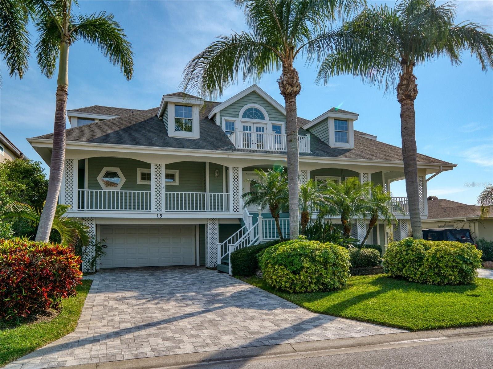 You will be captivated by the open water views surrounding you in this custom home. The open water view here is exceptional and looks to the south and west. The sunsets are truly breathtaking! The home is designed for easy living with a great room plan featuring soaring ceilings and walls of windows. There are 4 bedrooms and 4 baths and the master is on the main living level with a beautifully remodeled bath. This Key West-style home has covered porches front and back taking full advantage of the water views and breezes. The outside area captures every essential for maximum enjoyment of the waterfront lifestyle. A lovely dock, boat lift, and separate kyack/paddleboard lift cover all the bases with a saltwater pool and spa to complete the picture. Belleair boasts three world-class golf courses, is convenient to all shopping and restaurants, and it is within minutes of the white sandy beaches. Just 30 minutes to Tampa International Airport and downtown St Petersburg.