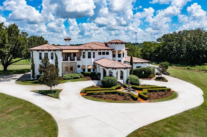 Welcome to this exquisite 2 story grand estate. This stunning 6290 sq ft luxury home is set on a meticulously landscaped 3.46 acres. Upon entering your private iron gate, you are greeted by impressive stone accents and a grand portico. This home is full of natural sunlight & exceptional details. Reclaimed chestnut wood flooring, antiqued marble & slate flooring, 10 ft Brazilian Oak doors, outstanding millwork & hewned beam details throughout. The gourmet kitchen will not disappoint boasting top of the line Wolf & subzero appliances including a 6 burner gas range with a warming drawer, beautiful custom Alder cabinetry that coordinates with the solid wood Alder interior doors throughout the home. The kitchen offers pull out drawers, spice racks, paneled appliances, stone countertops, subzero refrigerator, & a large island. The butler's pantry offers elaborate glass doors, a subzero ice maker and a reverse osmosis dispenser. The dining area accommodates family & friends for casual or formal meals and has mitered windows that overlooks the pool. The charming family room offers exposed wood beams that draw the eye upward, built in shelves w/ lighting & 10 foot tall triple glass sliders that lead to the lanai. The living room offers a double-sided gas fireplace shared with the office & picture windows overlooking the back yard. Your bar area has room for a pool table & boasts seeded antique glass cabinets, subzero Beverage fridge and a climatized wine room. There is a full bath located by the bar as well. Your restful retreat awaits you as the master suite is located at the far end of the first floor and offers his & her closets w/ plenty of storage space & a hand painted ceiling inspired by the Paris Opera House. The huge En-Suite is like having your own private spa boasting a Chromatherapy tub with led changing lights that butts up to the open shower with 3 shower heads & a glass wall overlooking a private garden. The shower has a rainfall shower head feature you can turn on while you soak in the tub & enjoy the peaceful, tranquil sound of water. A tankless heater provides an endless supply of hot water. As you take the Brazilian oak curving staircase with hand made iron railings there is a chandelier that has a lift for easy access. There are 3 oversized bedrooms, a bonus room and a W&D hookup. Two bedrooms share a private balcony that offers gorgeous sunrise views & overlooks the peaceful backyard & expansive conservation land beyond. No backyard neighbors ever. The 900 sq ft bonus room offers endless possibilities and a private balcony that overlooks the front yard. This house is perfect for entertaining with the extensive screen enclosed Slate floor lanai & the huge lagoon pool that offers built in seating, a table & a huge sun shelf with a bubbler. There are so many different areas to this lanai- there is a cozy sitting area with a fireplace, an area that houses a Caldera spa and a huge outdoor living area that offers a fountain & outdoor kitchen. There is a shower stall and a 1/2 bath on the other side.  There is a wood burning firepit in the back yard offering the perfect place for a family smores night. The laundry room has tons of storage w/its beautiful cherry wood cabinetry w/ a rub thru technique. Extremely upgraded cabinets throughout this house. 60,000kw generator that will run the entire house. Thanks to the 1000 gallon buried propane tank. There is a huge parking pad w/a 30amp RV hookup. Bring your Toys! No HOA or CDD fees!