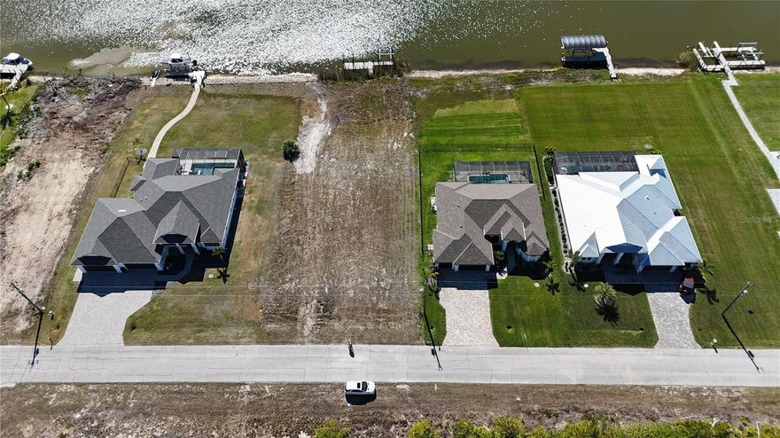 Prime waterfront lot opportunity. This exceptional 80' x 125' waterfront lot in Waterview, Section 94 of South Gulf Cove, a deed restricted community, offers direct access to Charlotte Harbor and the Gulf of Mexico with no fixed bridges. This lot located on the Santa Cruz Waterway a deep-water canal suitable for sailboats. The lot has rear southern exposure ensuring ample sunlight and warmth throughout the day. It also features a picturesque view of the preserve across the waterway, enhancing privacy and offering serene, scenic beauty. Past the greenbelt, that the HOA owns for conservation and protection, there is a dock with a boat lift in place, but both require updating. The neighborhood is experiencing growth, with new custom-built homes emerging on Liggett Circle and surrounding streets, making this area one of the most unique and sought-after for Gulf access in the area. South Gulf Cove provides residents with a variety of amenities, including a boat ramp, playground, clubhouse, and parks. These features allow residents to fully enjoy the beauty and recreational opportunities that Florida has to offer. Prospective buyers and their agents are encouraged to verify all homeowners' association (HOA) uses and restrictions, environmental conditions, and any endangered species restrictions associated with this lot before proceeding with a purchase.