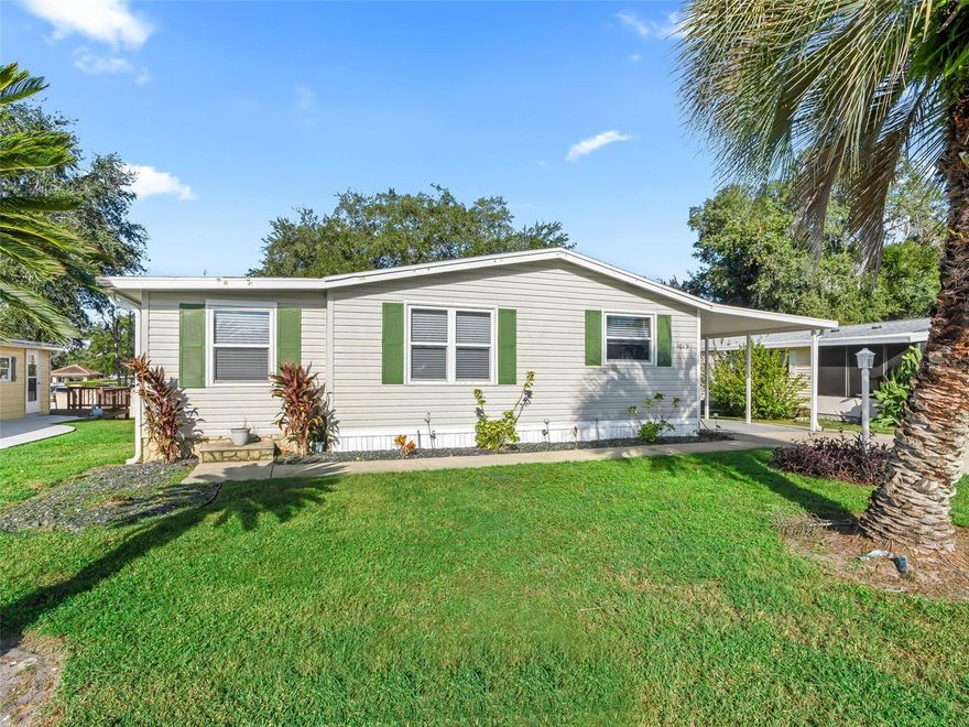 Turn-Key 2/2 Manufactured Home in Country Club Hills. This wonderfully maintained and modern turn-key 2-bedroom, 2-bath manufactured home features a newer roof installed in 2023. Situated in the highly desired Village of Country Club Hills, the property offers privacy with no homes located behind it. Residents will enjoy easy access to excellent golf courses, swimming pools, and recreation centers, all just minutes away. The home is conveniently close to Spanish Springs Town Square and is positioned along the Highway 27/441 corridor, providing an abundance of nearby shopping opportunities. Inside, the home boasts a host of modern updates and amenities. The kitchen is equipped with white cabinets accented by decorative hardware, granite countertops and tile backsplash, and stainless-steel appliances. Laminate flooring extends throughout the entire home, creating a cohesive and stylish look. Both bathrooms, as well as the hall desk and buffet area, feature granite countertops for a touch of elegance. The spacious primary suite is beautifully furnished and includes vaulted ceilings and a large walk-in closet. The primary bathroom offers ample space and a walk-in shower for convenience and comfort. The guest bedroom also features vaulted ceilings and a generous closet, making it an inviting space for visitors. Designed for entertaining, the open layout of the living and dining area is ideal for hosting family and friends for any occasion. A bonus area provides the perfect spot for card games, hobbies, or a round of darts. From this space, step into the private screened-in lanai to enjoy a relaxing evening. The golf cart garage includes a laundry area complete with a washer and dryer, as well as plenty of room for storage. The covered patio and carport have been freshly painted, adding to the home's overall appeal.